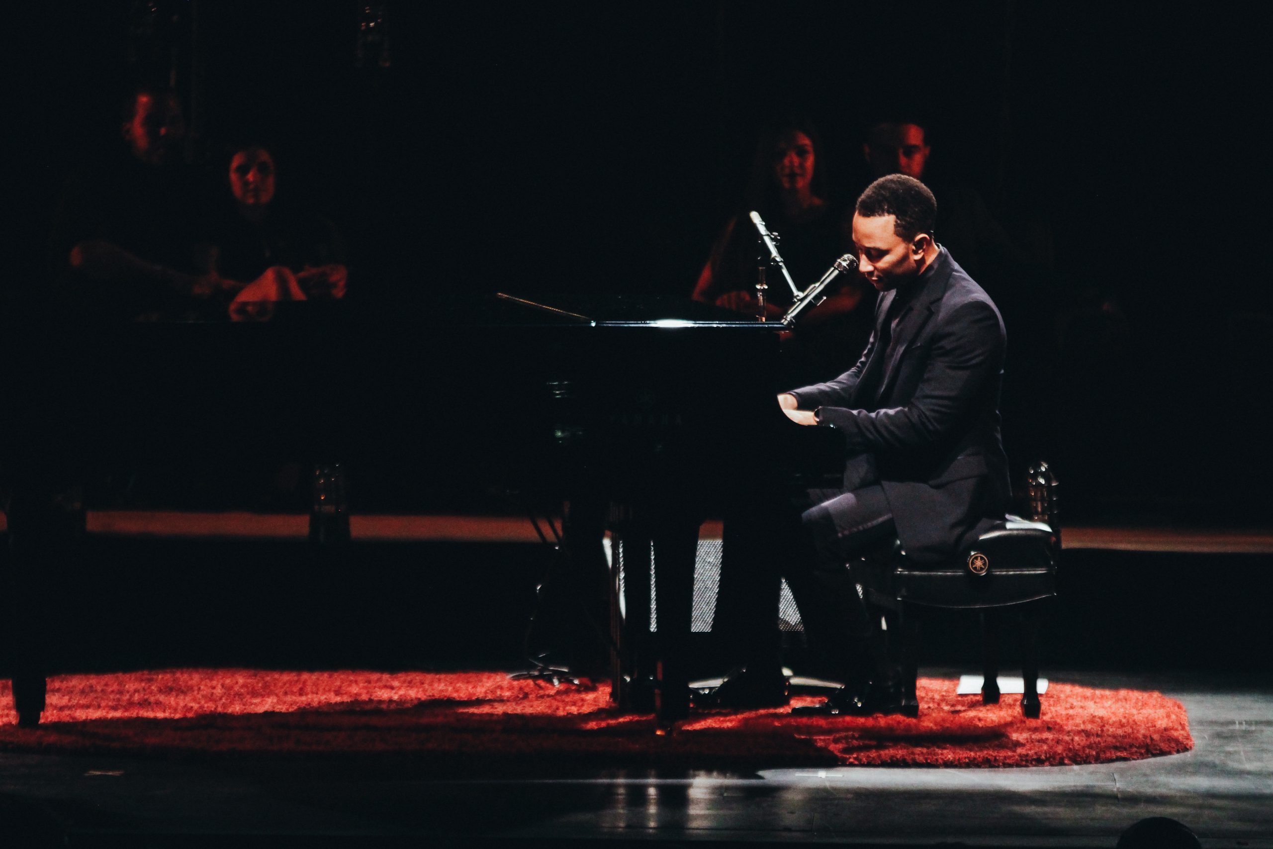 Side profile of John Legend on stage