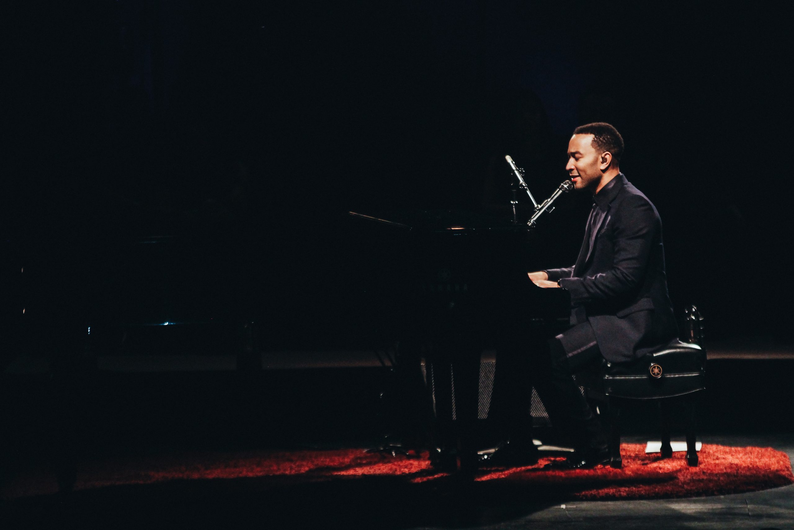 Side profile of John Legend on stage