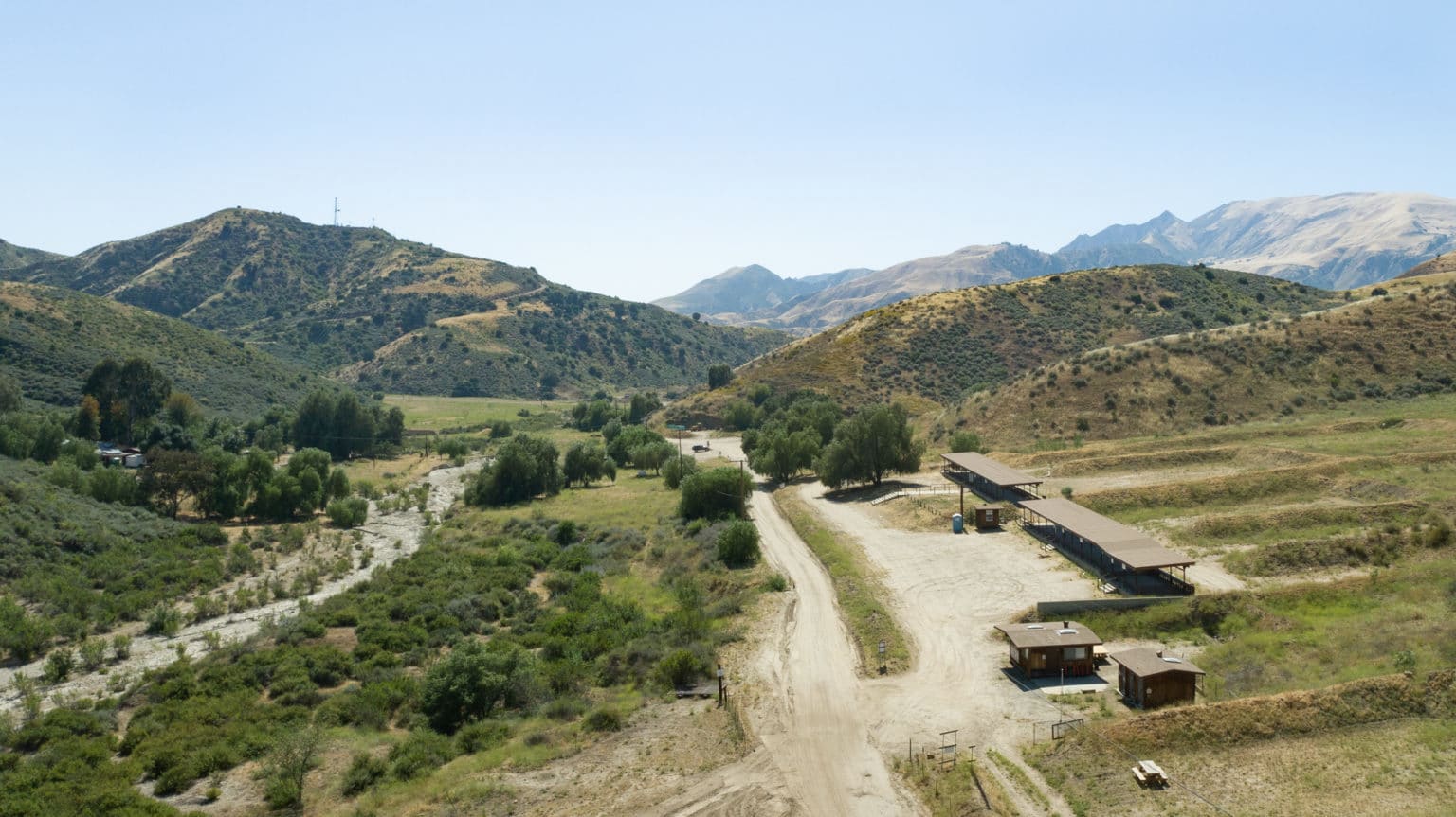 Aerial view of valley with buildings, hills and mountains