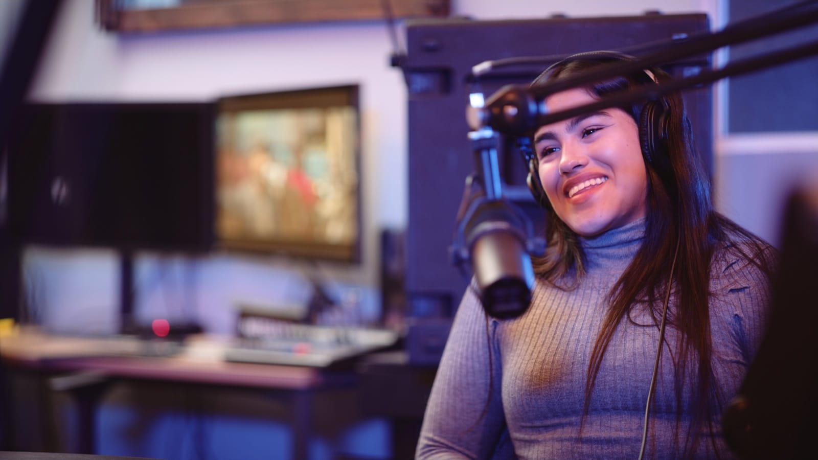 Woman smiling by a microphone