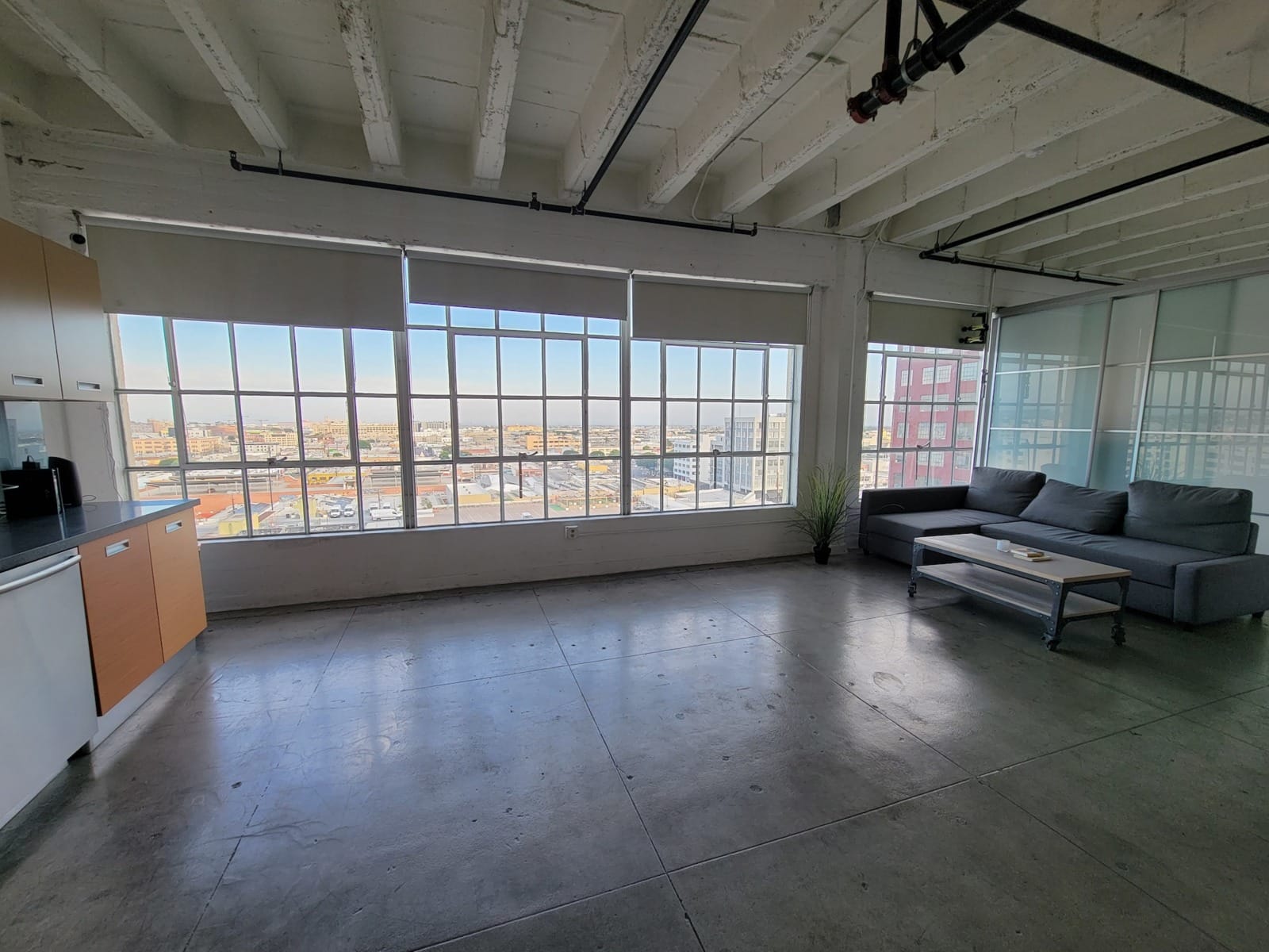 LA Filming Locations View of a room with gray couch, table and counter