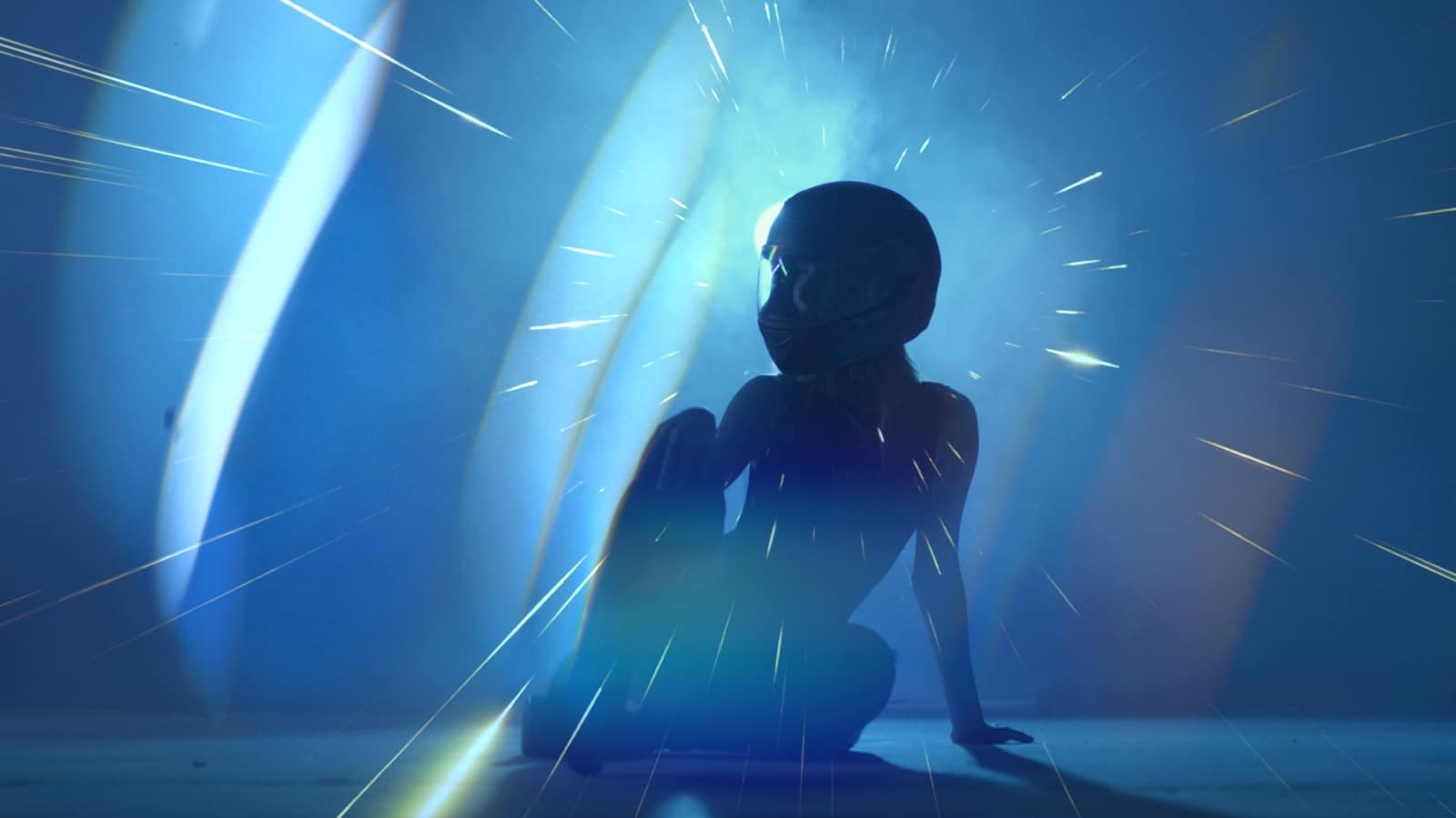 Storytelling through Brand Video Tips Woman sitting on the ground wearing a motorcycle helmet in bluish light