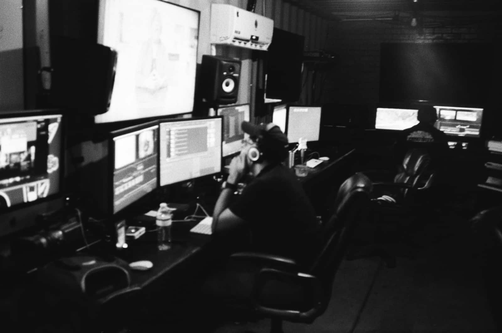 The Importance of Sound Design in Video Production Black and white side profile of two staff members working on desktops