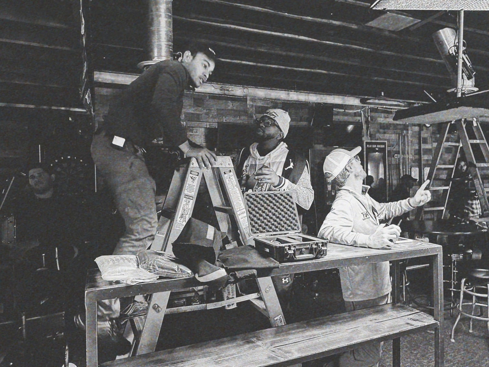 What Makes a Great Art Director Black and white of three male crew members working on set