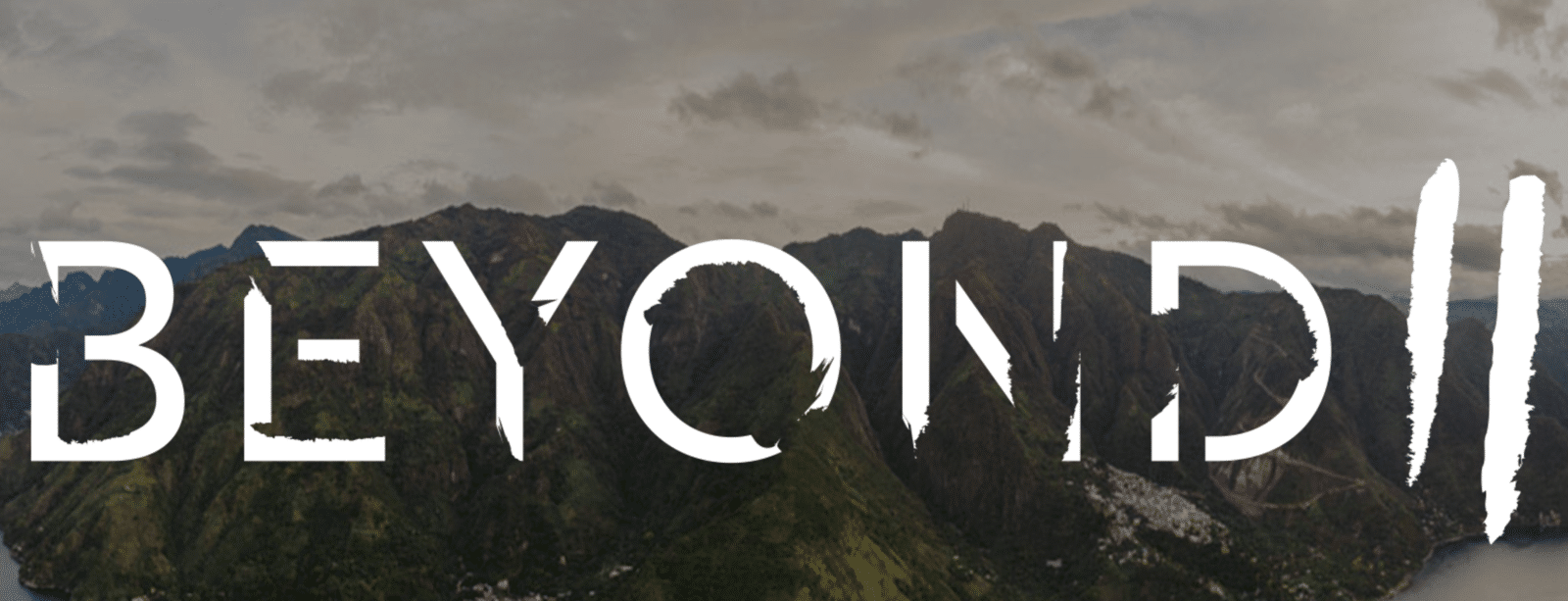 The Role of Typography in Logo Design White Beyond II logo against mountain backdrop