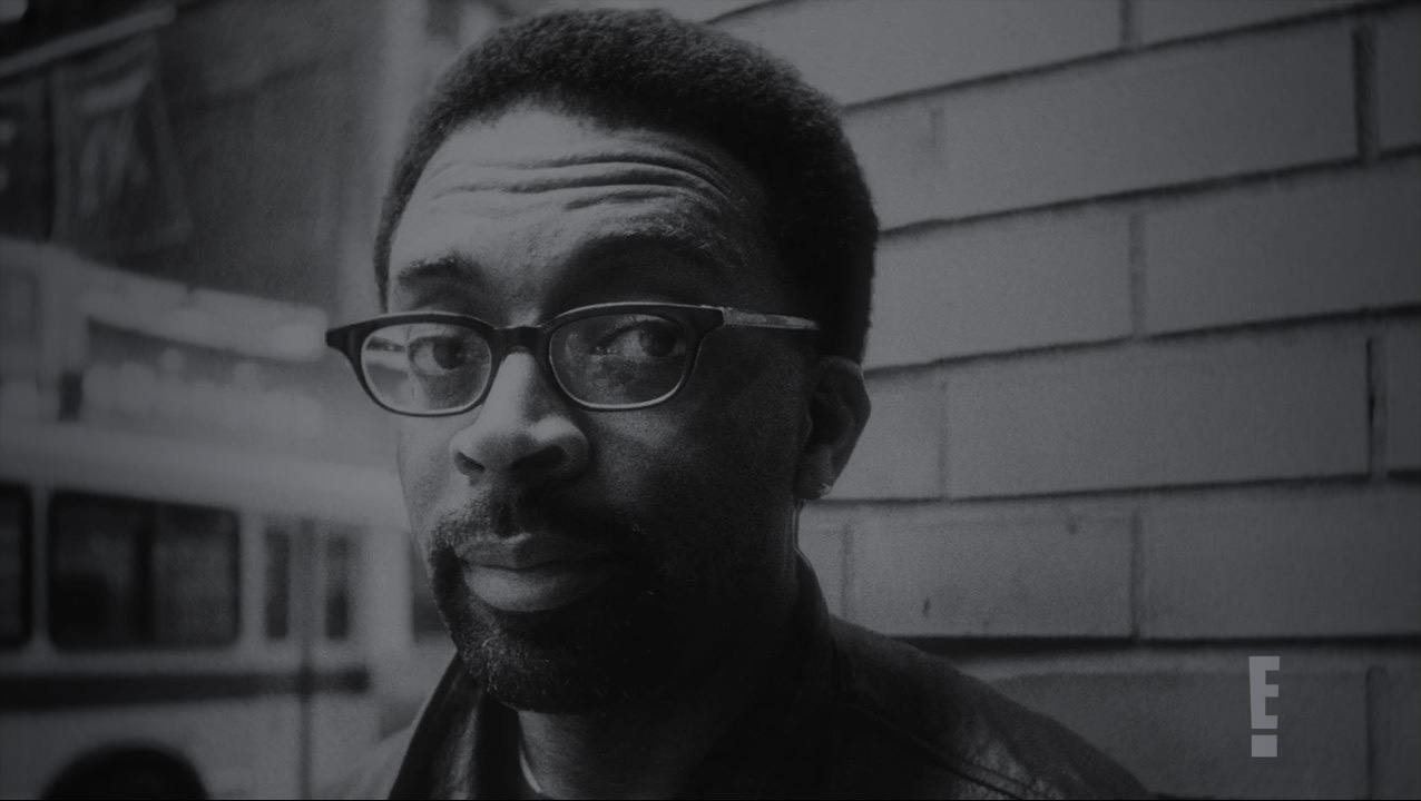Black and white image of Spike Lee looking toward the viewer