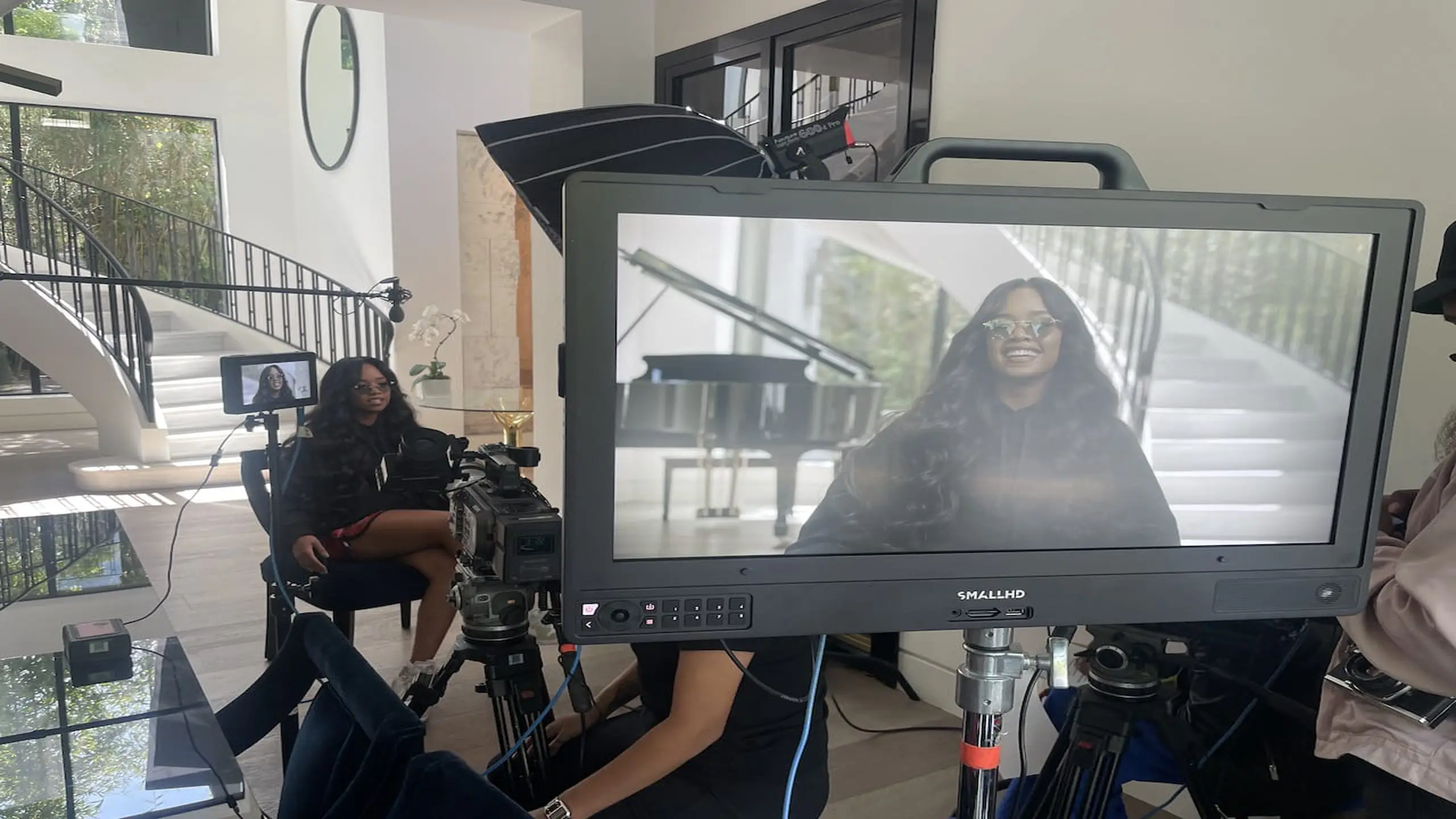 H.E.Rl on set with crew and equipment with video display in the foreground