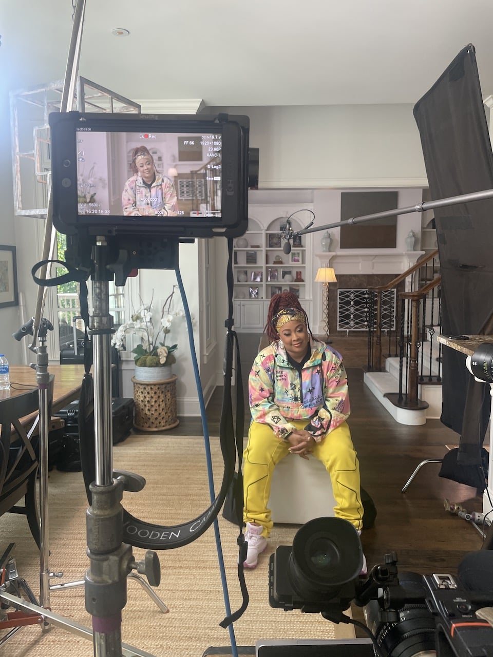 Closeup of video display with DaBrat sitting on set nearby