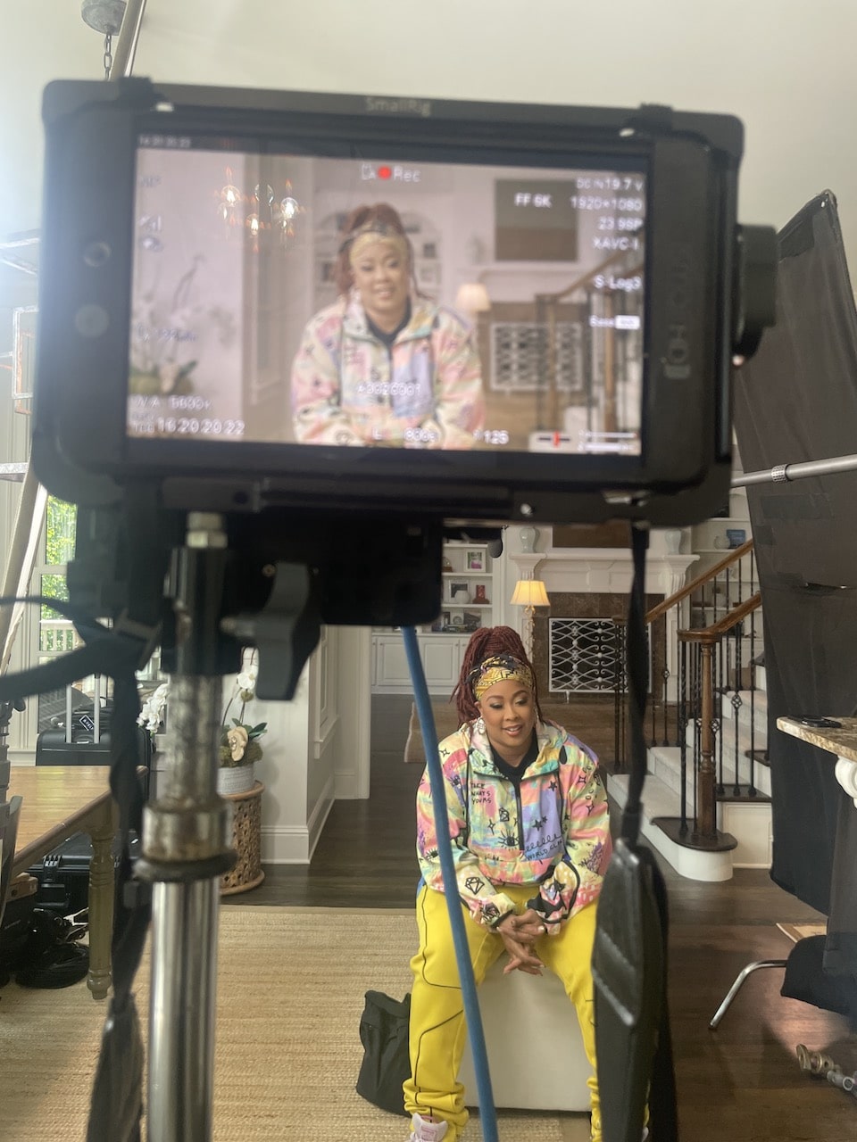 Closeup of video display with DaBrat sitting on set nearby