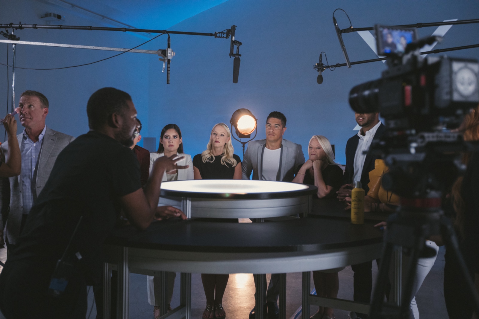 Joshua speaking to crew gathered around a table