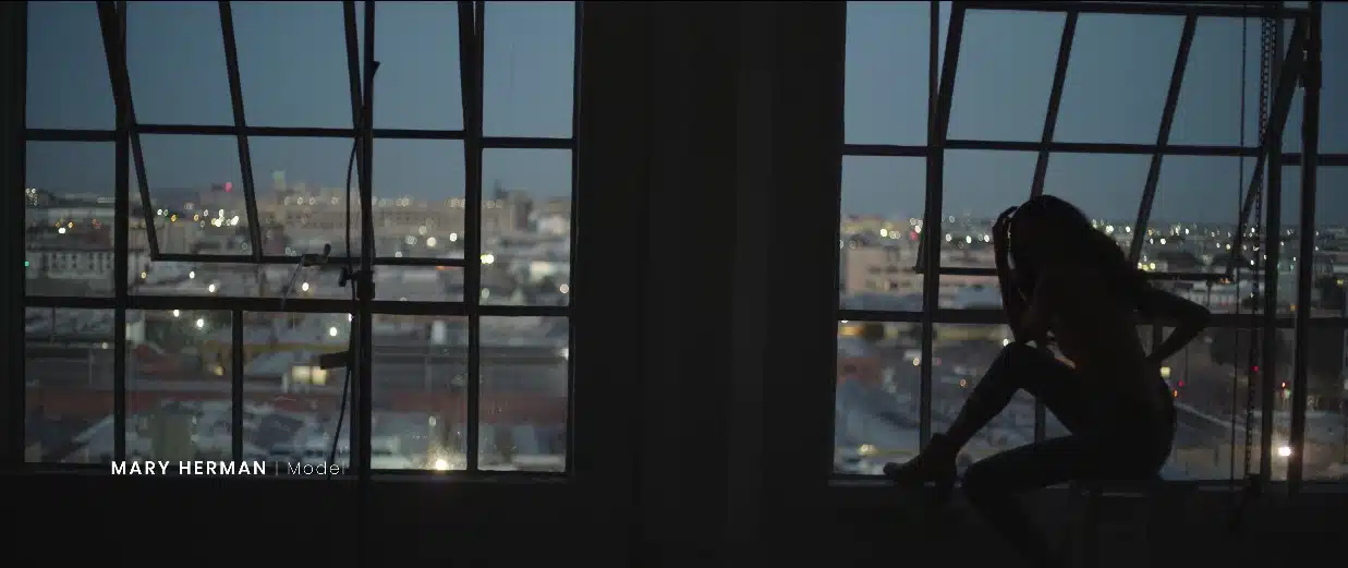 IU Model image of Mary Danielle Herman/Dani Oliveros sitting near a window inside a loft
