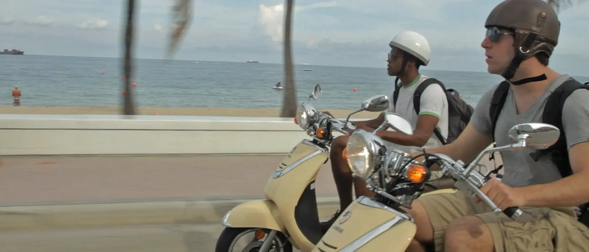 cis-page-tv-show-pitch12 Side view of two men on scooters on a beach