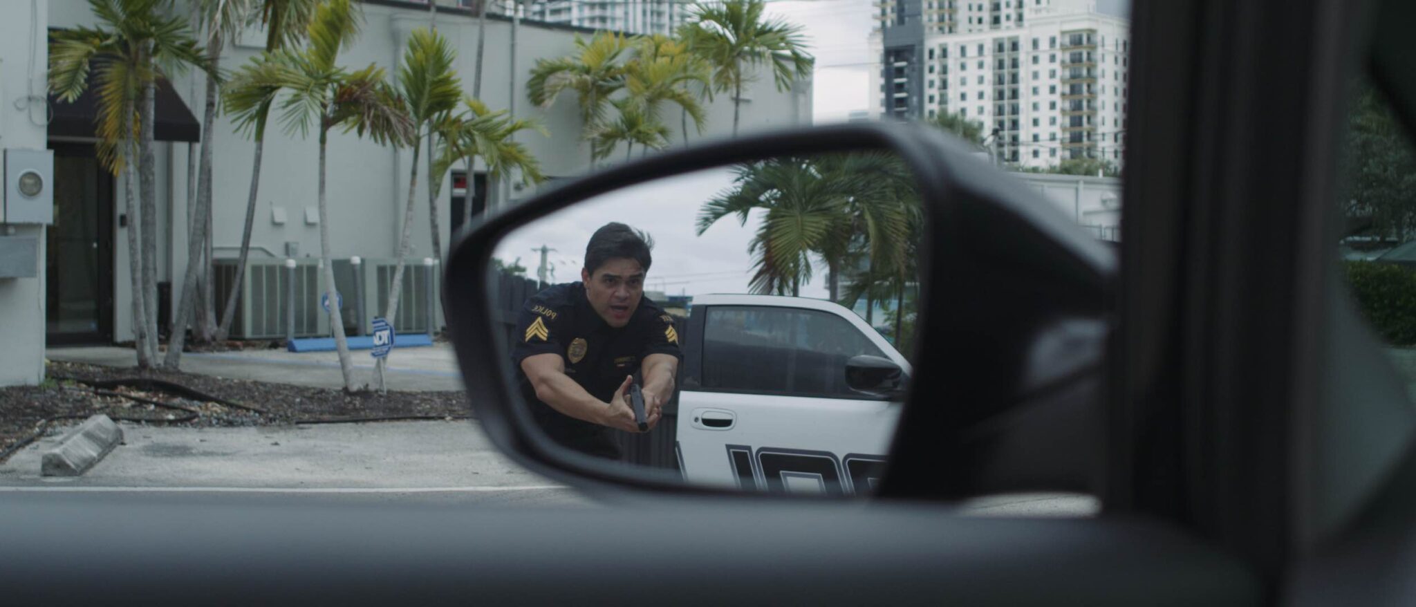 Black Violin One Step Music Video View of cop in a car side mirror with gun drawn