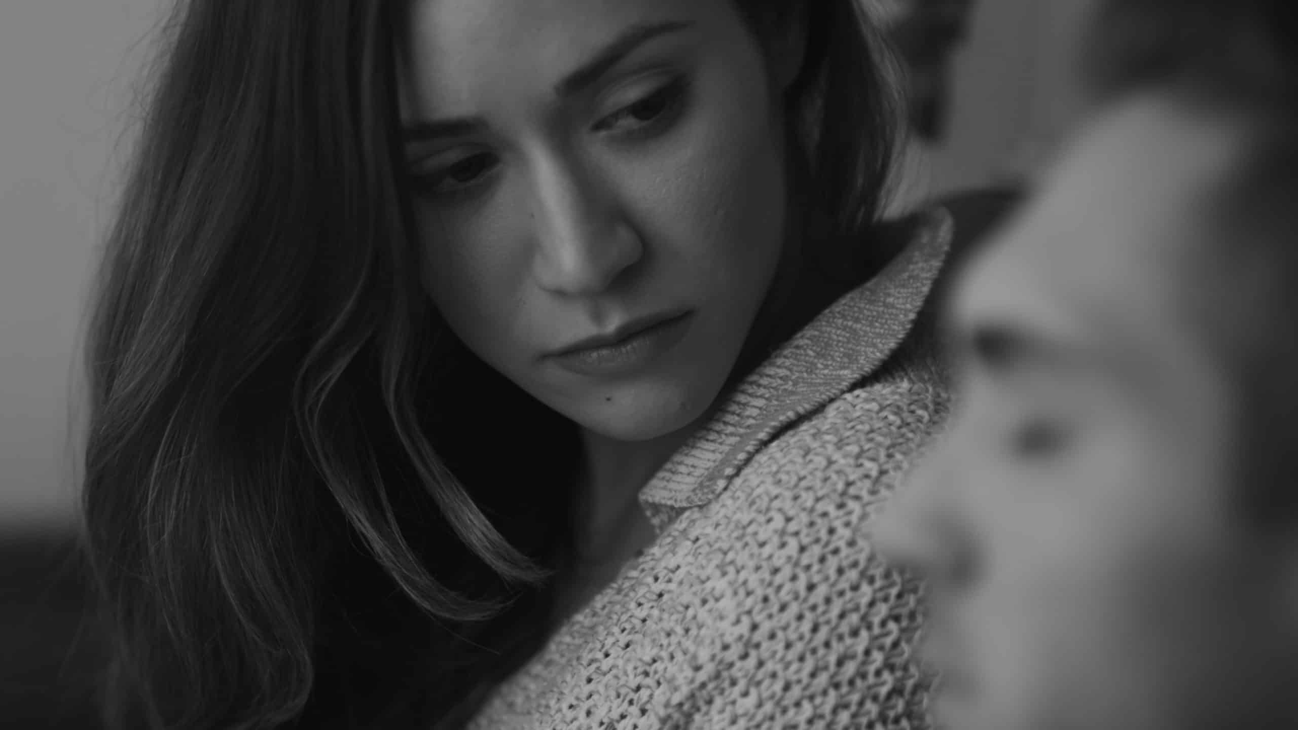 Black and white side profile of woman looking at man