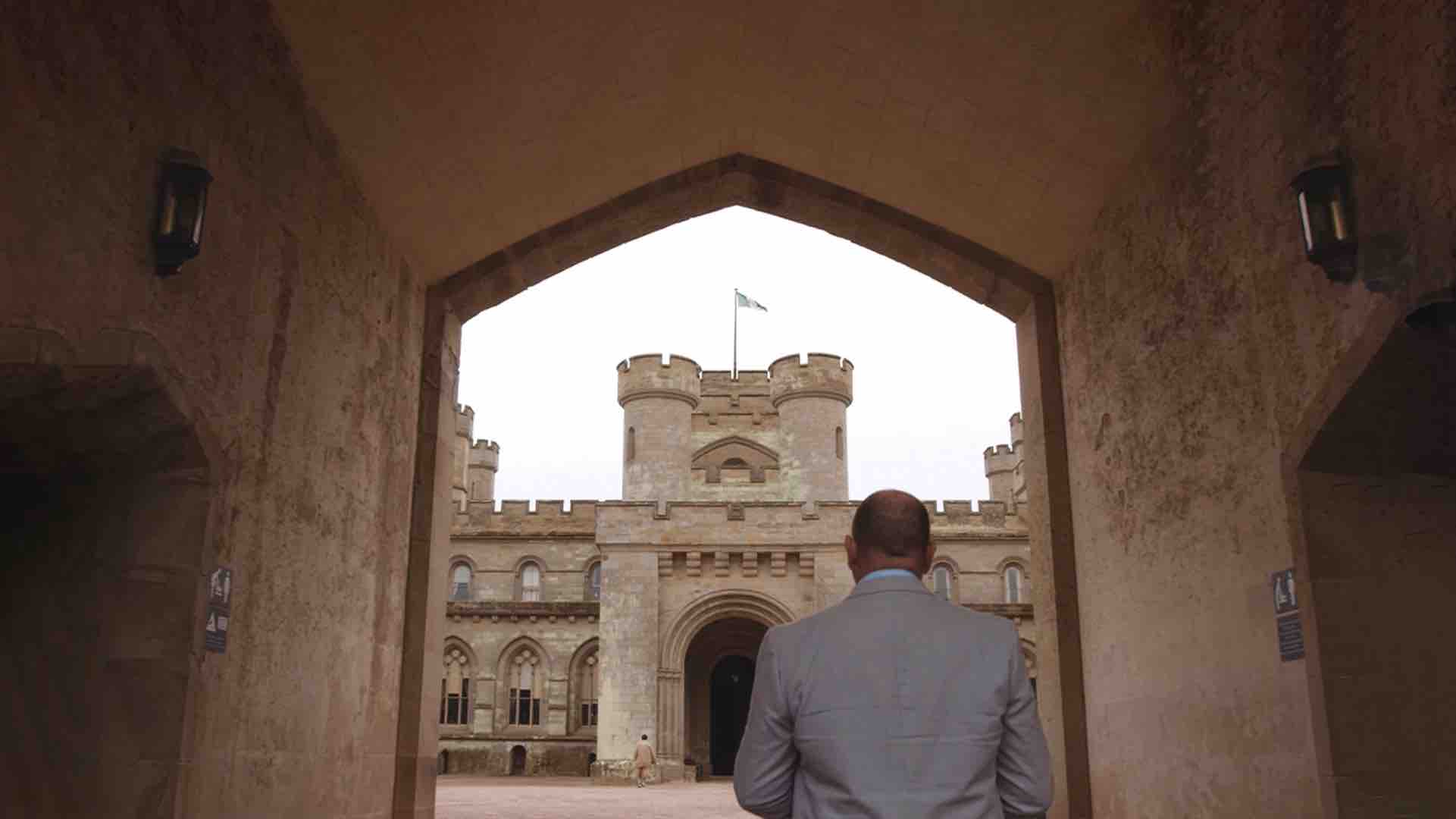 View from behind of man looking at castle