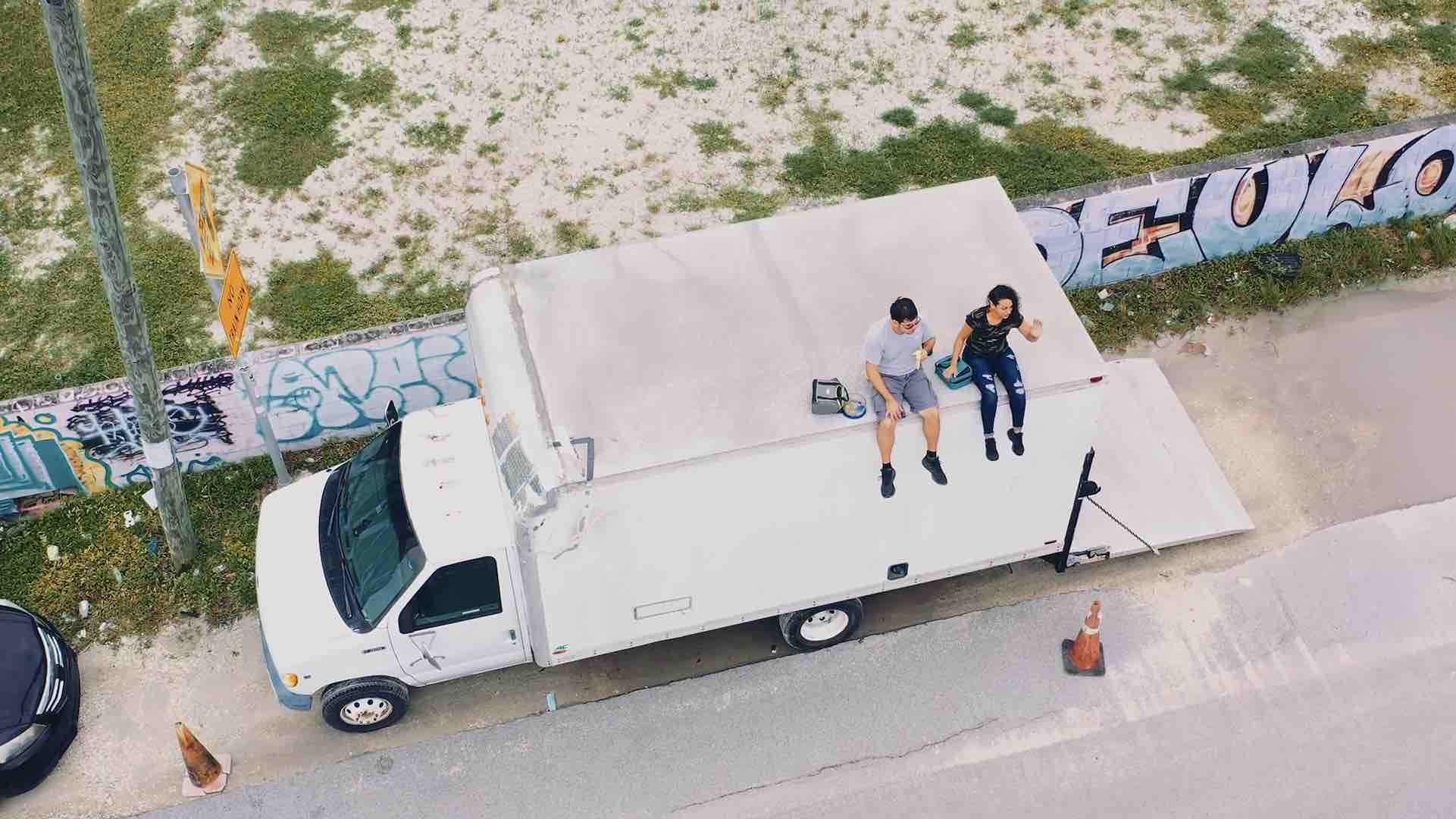 Overhead view of two crew members sitting on a box truck