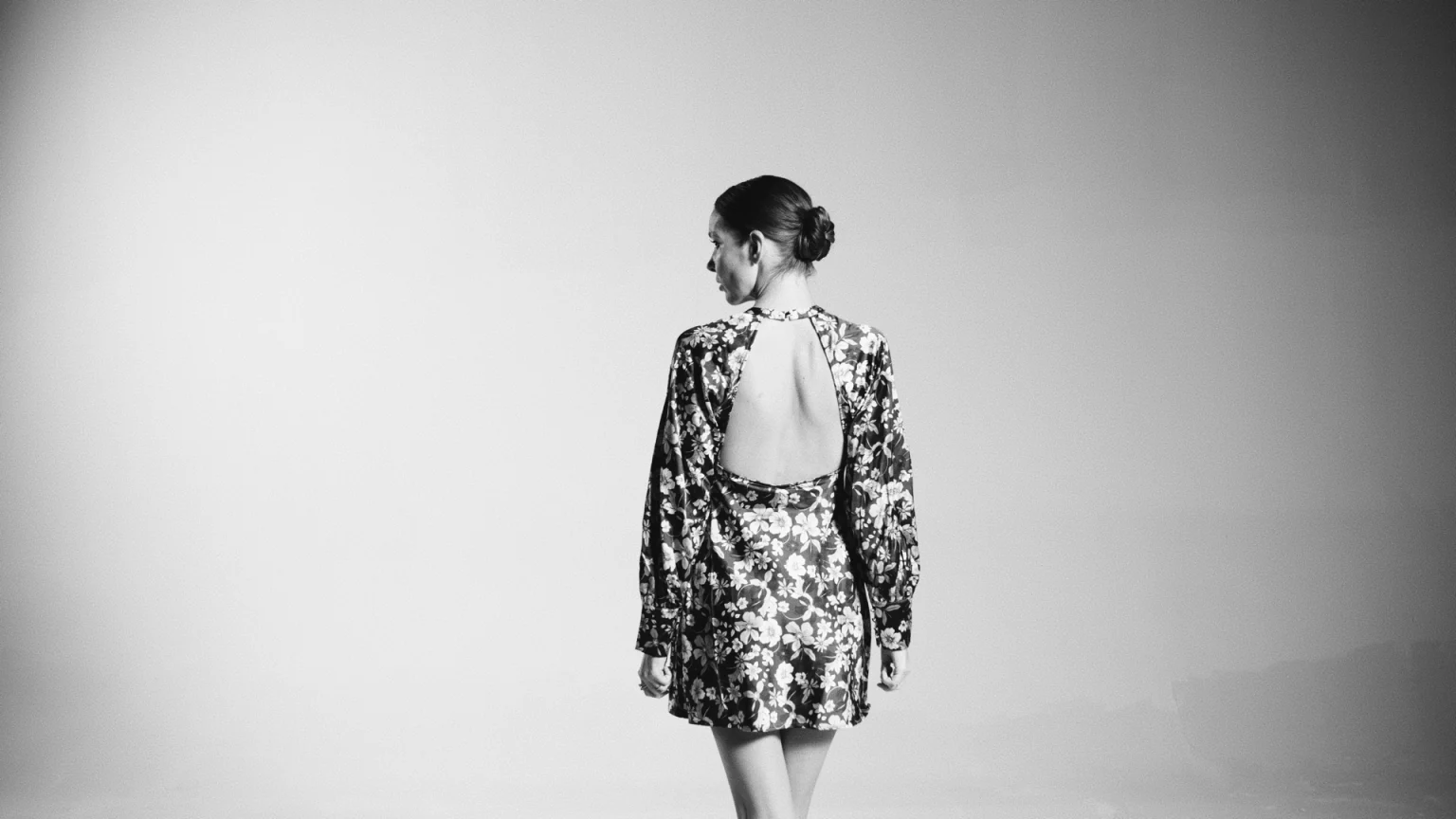 Black And White View From Behind Of Woman Wearing A Flowery Outfit