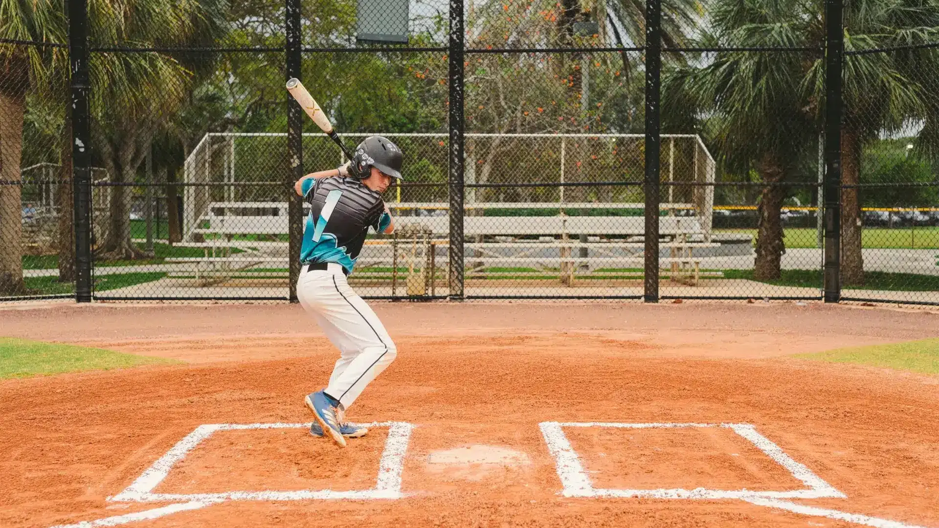 cis-portfolio-ball-cap-liner2a Young male player poised to hit a baseball on a baseball field