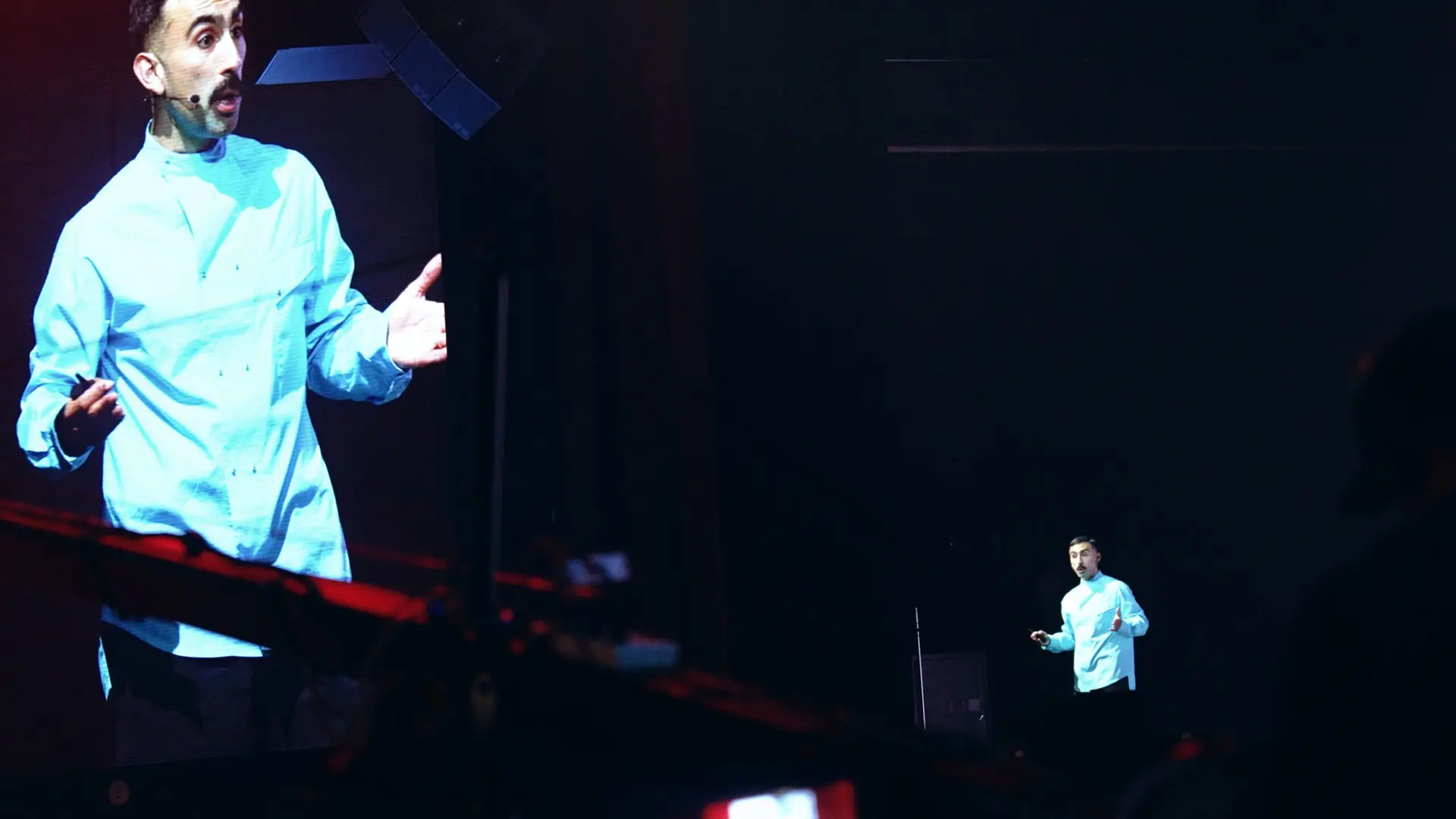 H&M 89 Man talking on stage seen on monitor