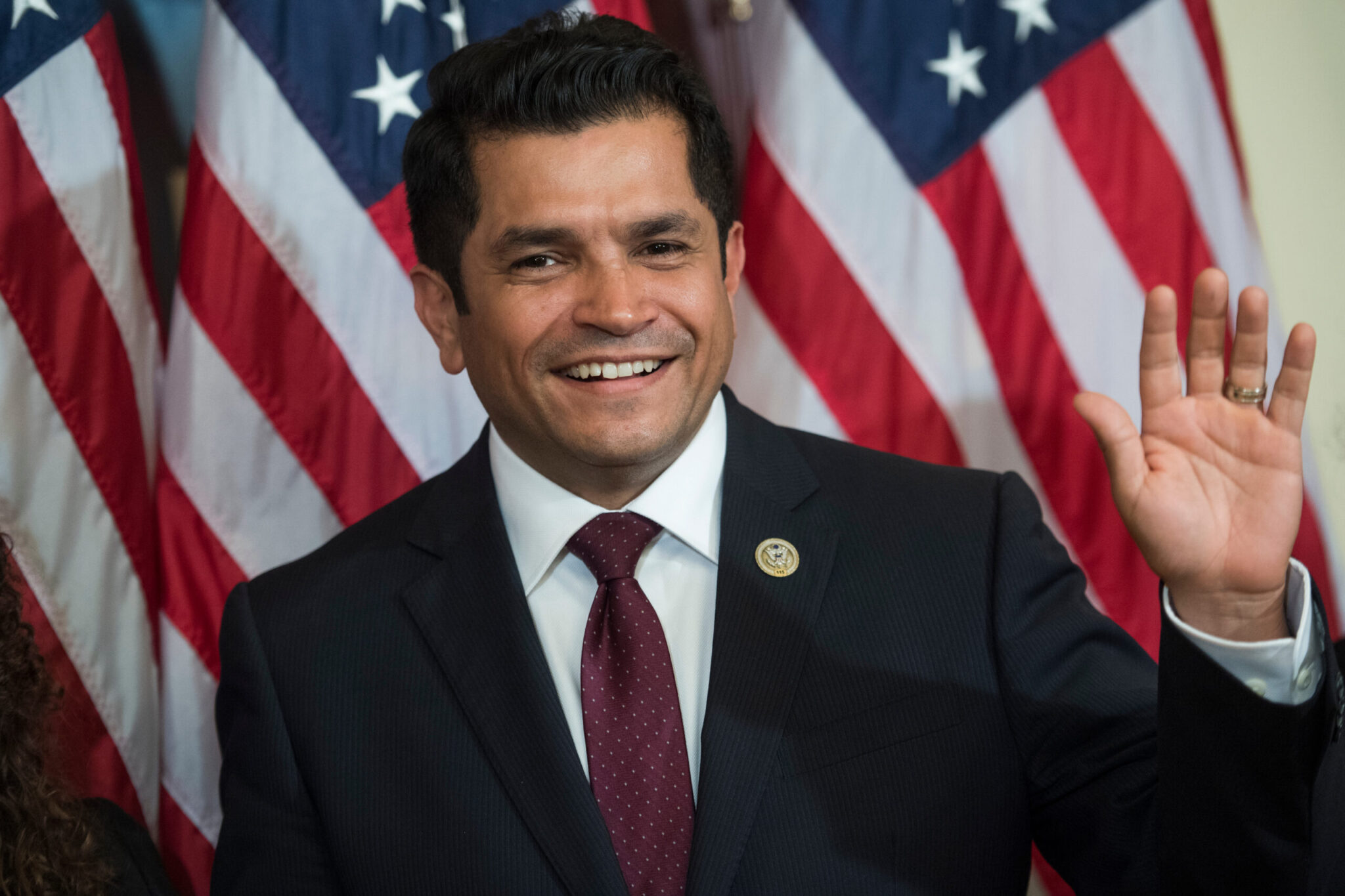 Jimmy Gomez smiling and waving posing for camera