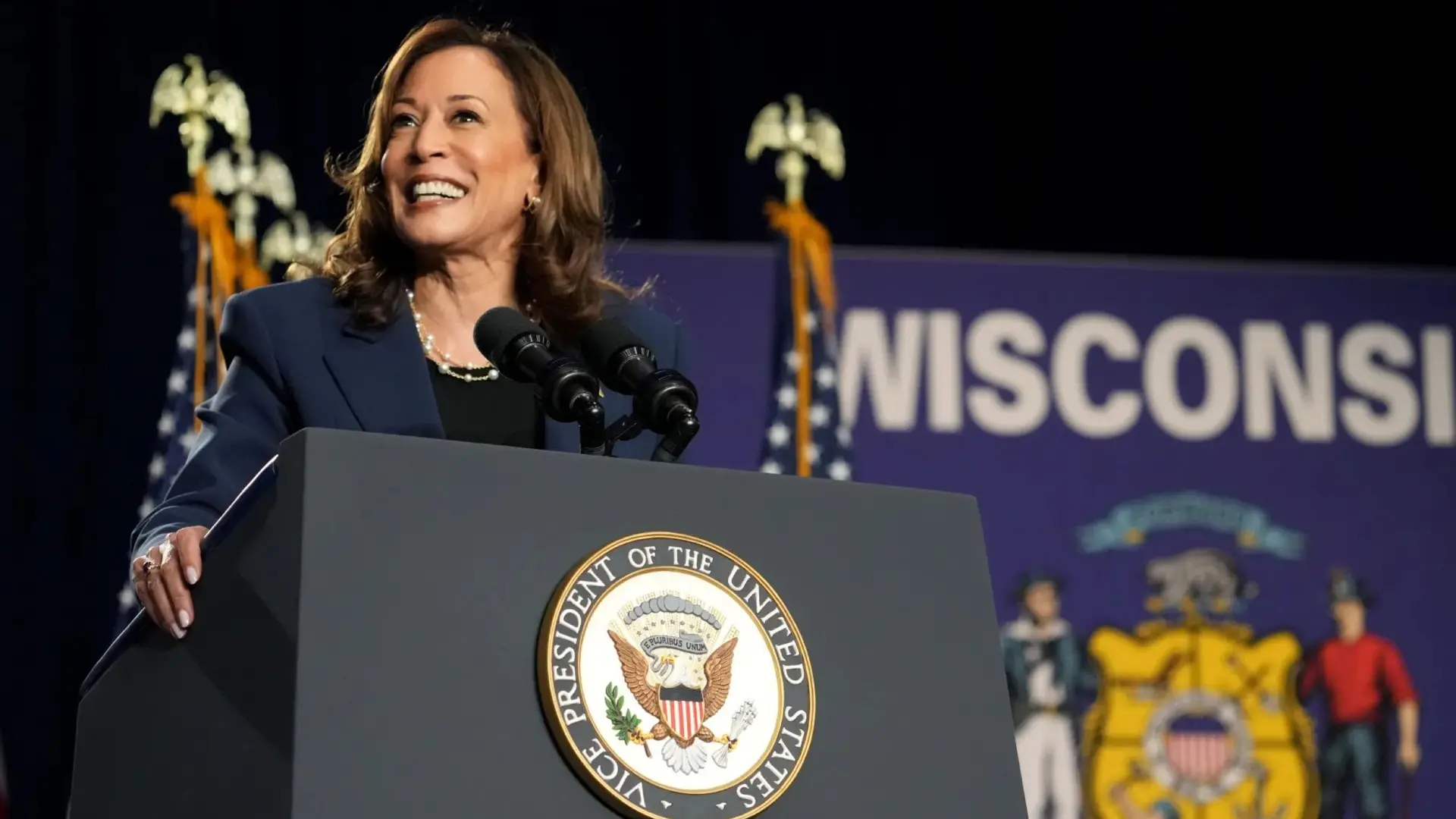 Kamala Harris 17 Kamala Harris smiling behind podium