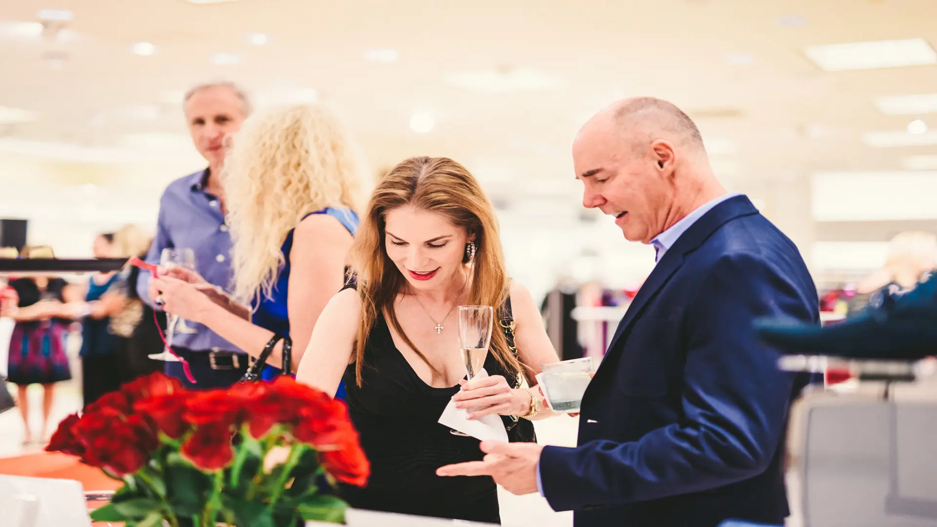 Neiman Marcus 14 Two men and women talking with women holding champagne glassess