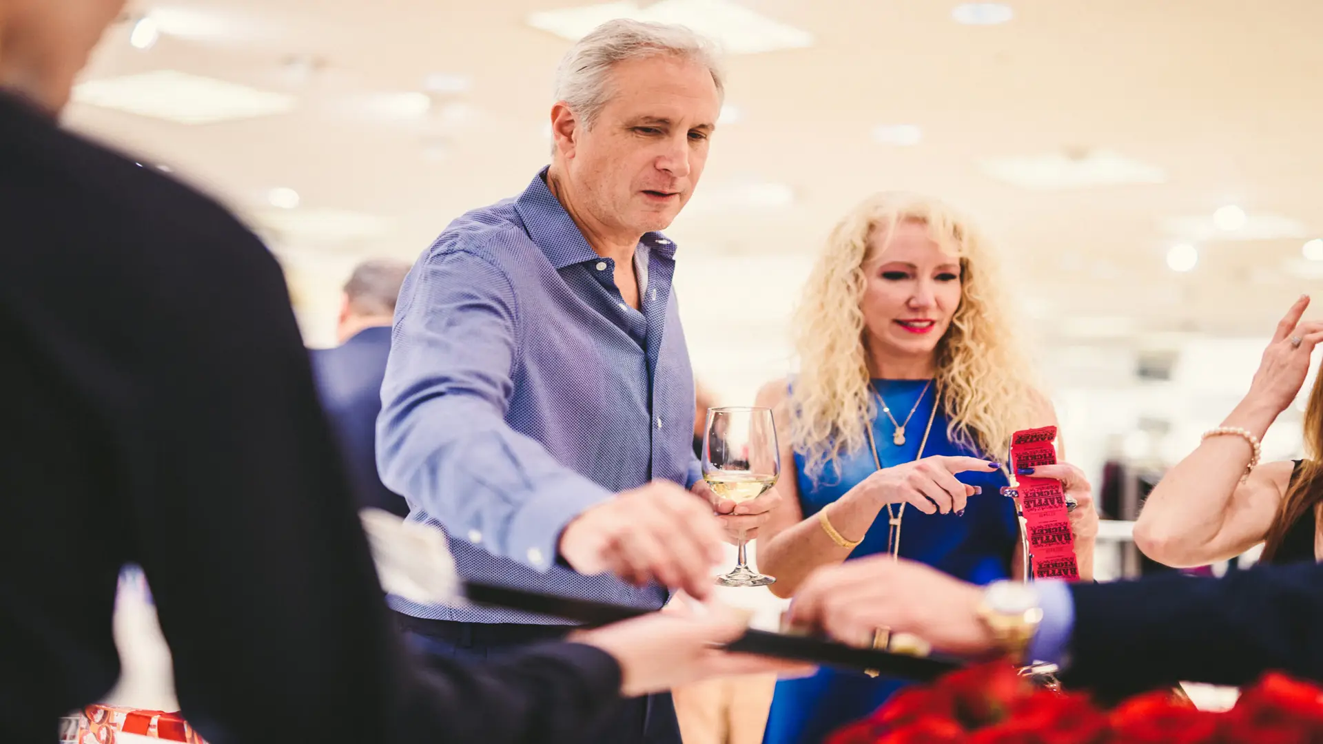 Neiman Marcus 15 Man and woman looking at tickets