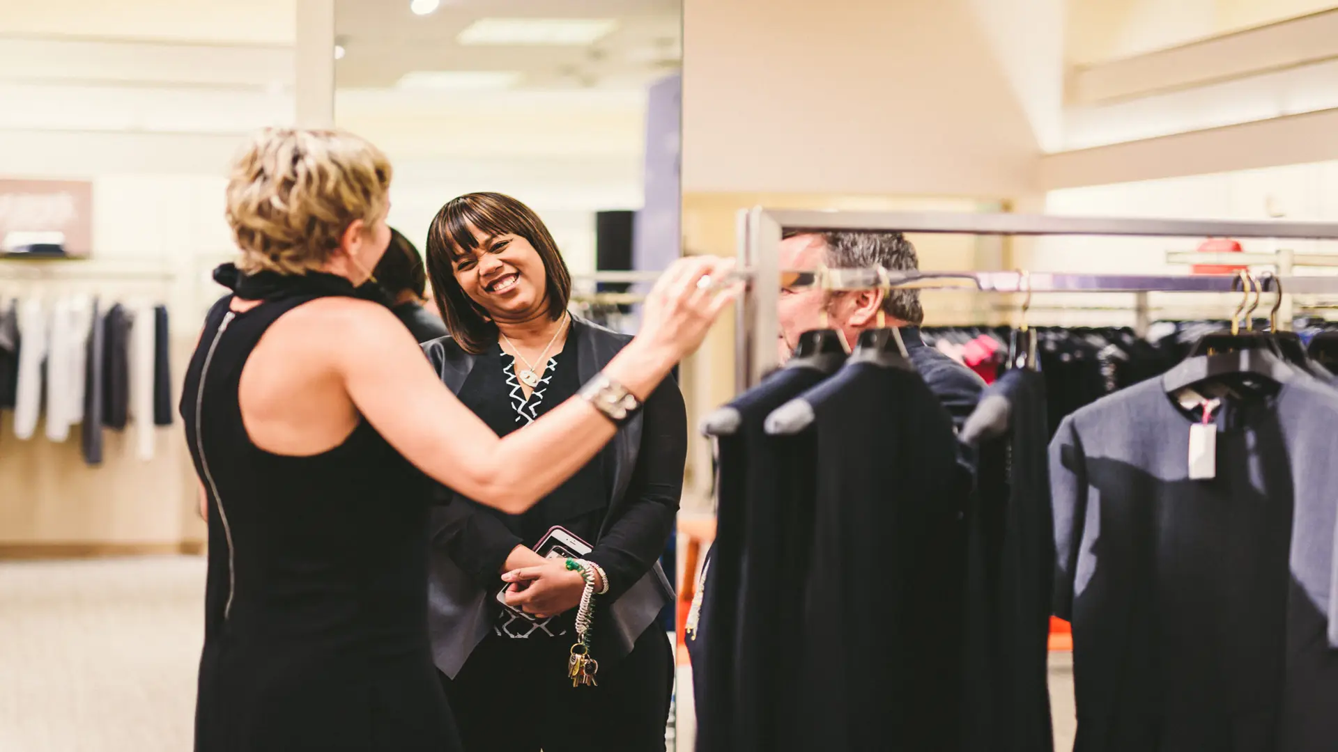 Neiman Marcus 23 Two women talking by rack of clothes