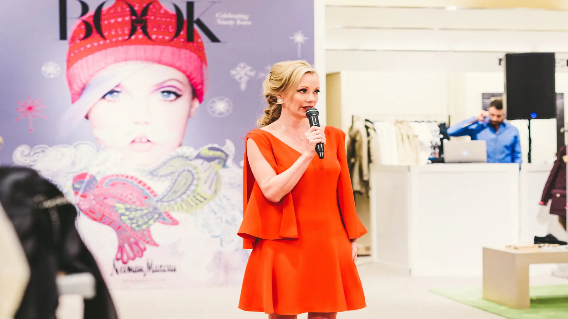 Neiman Marcus 6 Woman dressed in red holding microphone