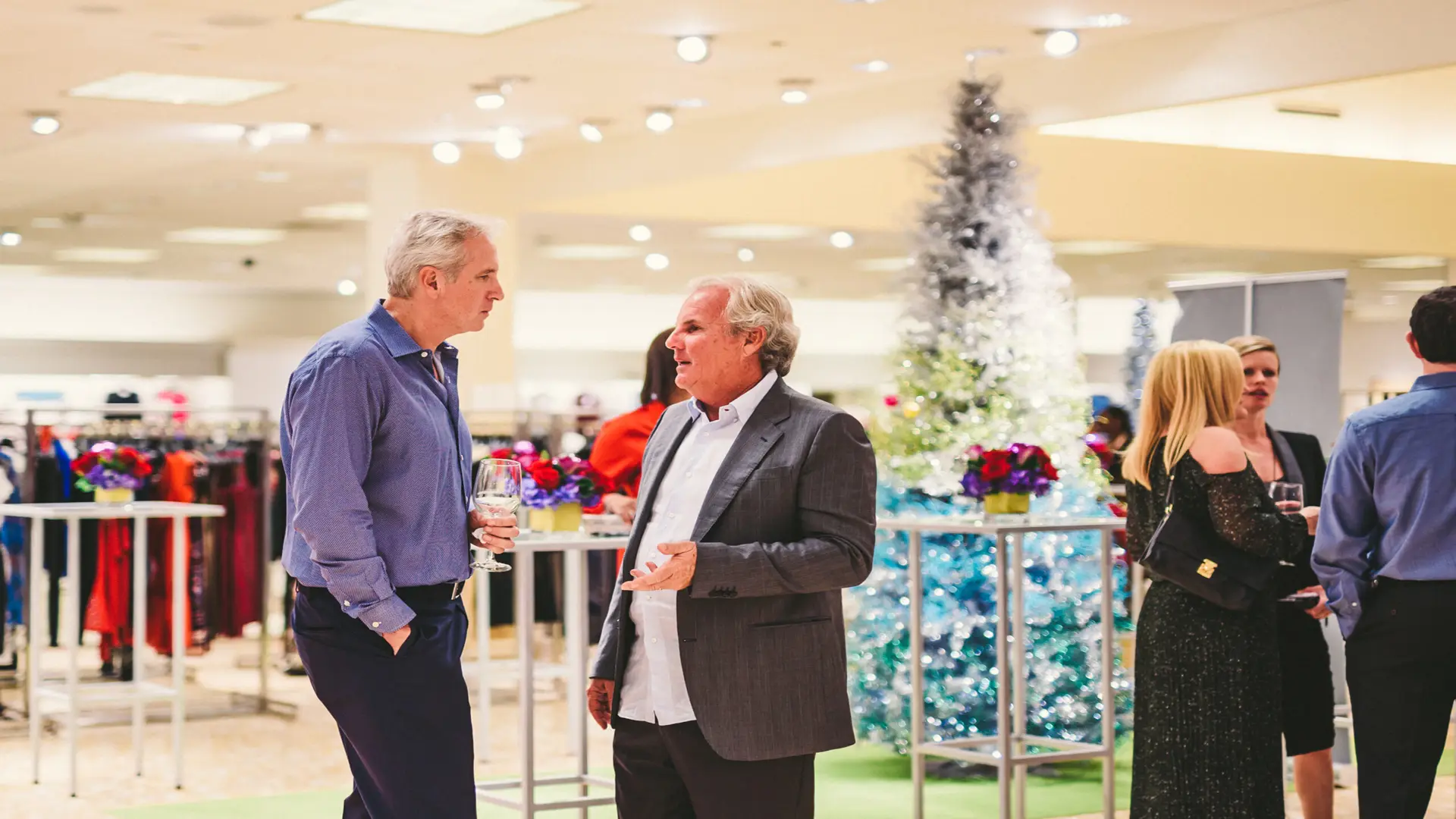 Neiman Marcus 25 Two men talking with others around
