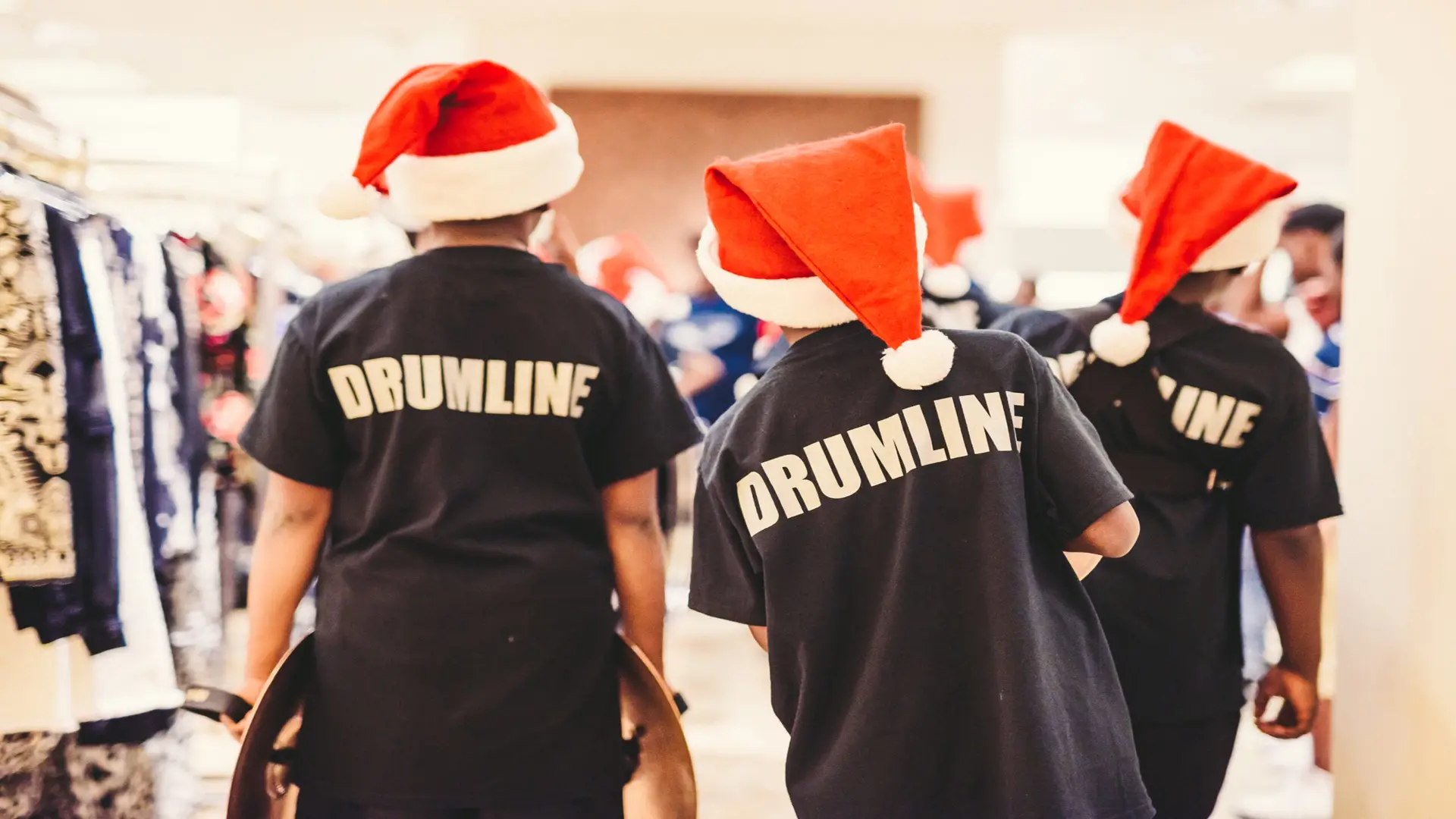 Neiman Marcus 10 View from behind of three children wearing Santa hats