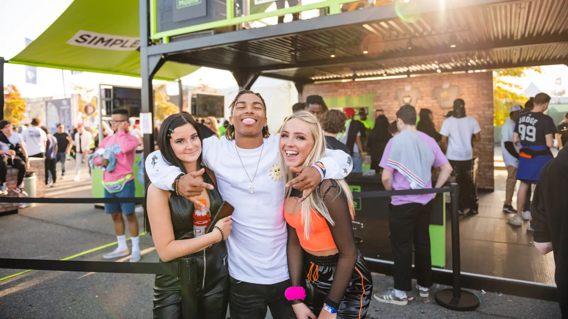 Rolling Loud 4 Man posing with two women for camera