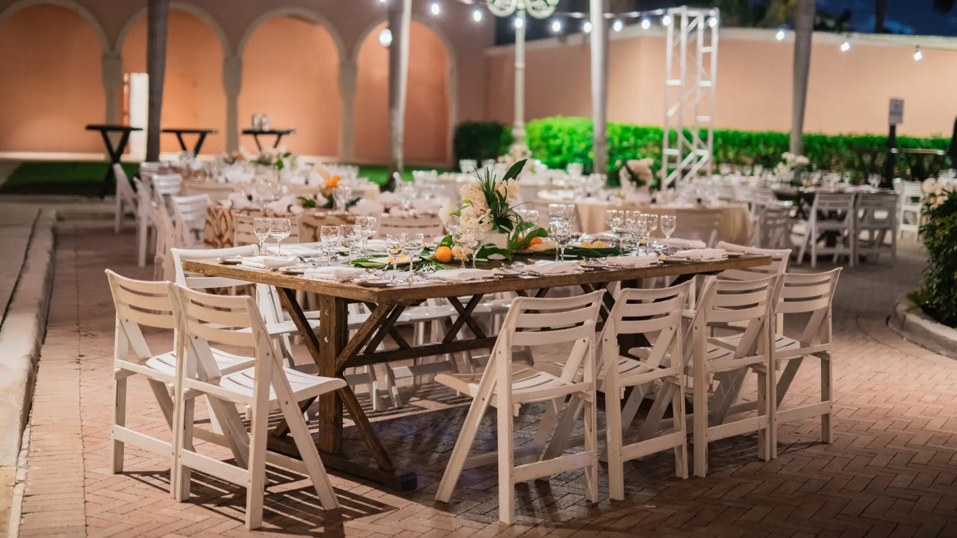SFBTA 16 Wooden tables and white chairs in courtyard