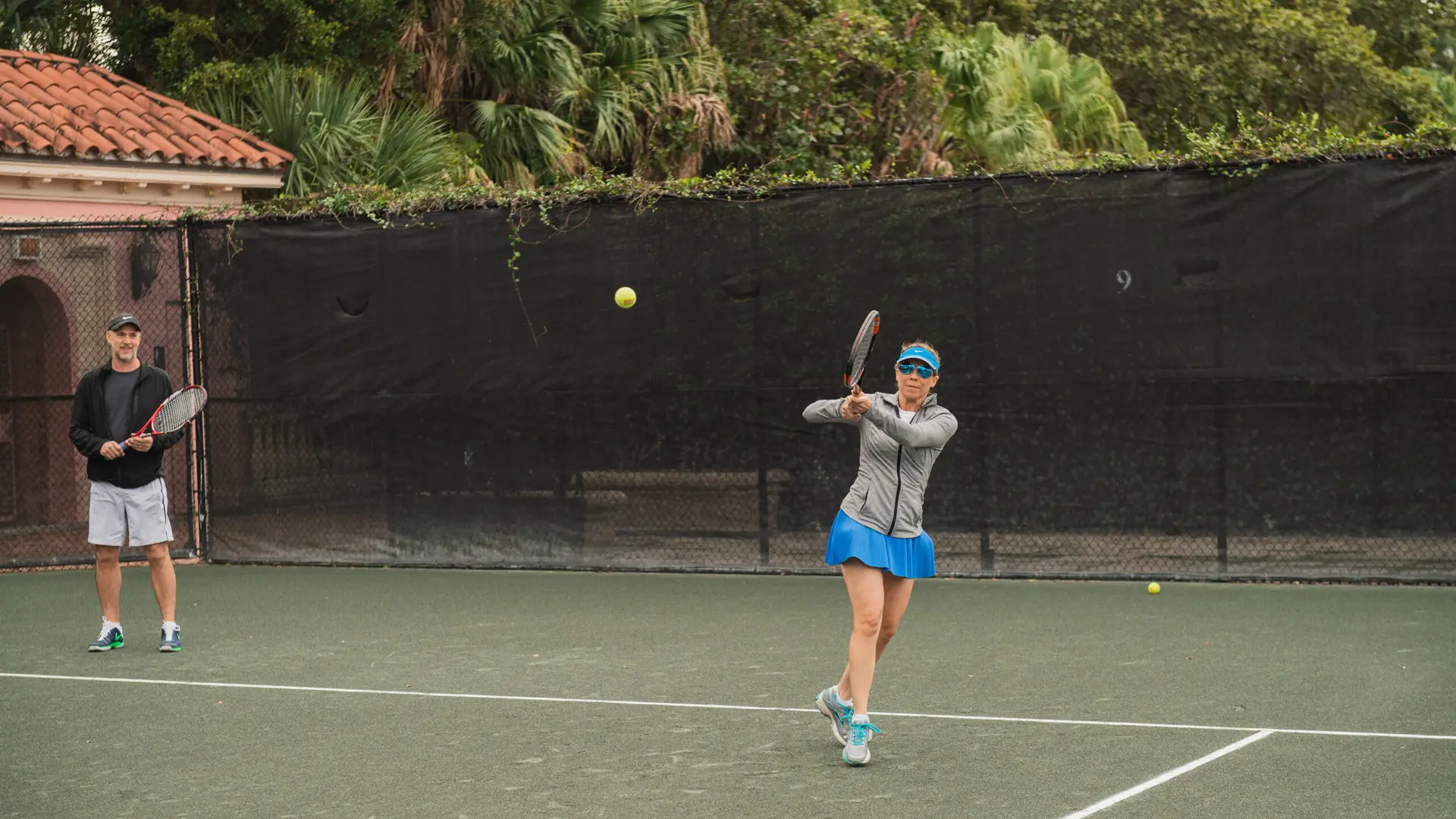 SFBTA 38 Woman playing tennis with male partner next to her
