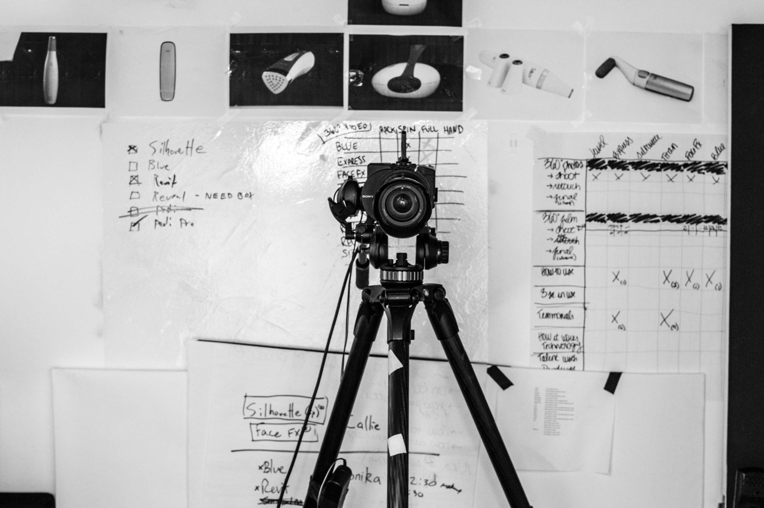 Camera on a tripod with film notes and shot list in the background