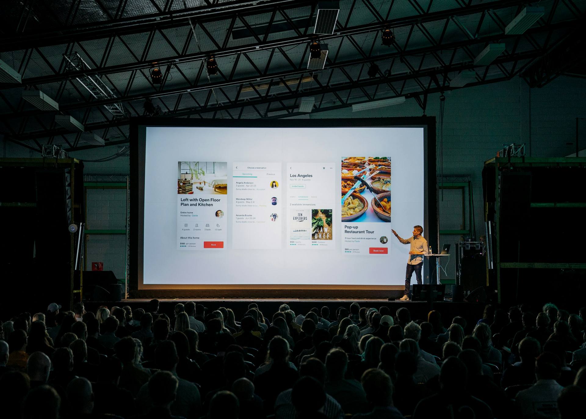 Man giving a presentation in front of a theater-style audience