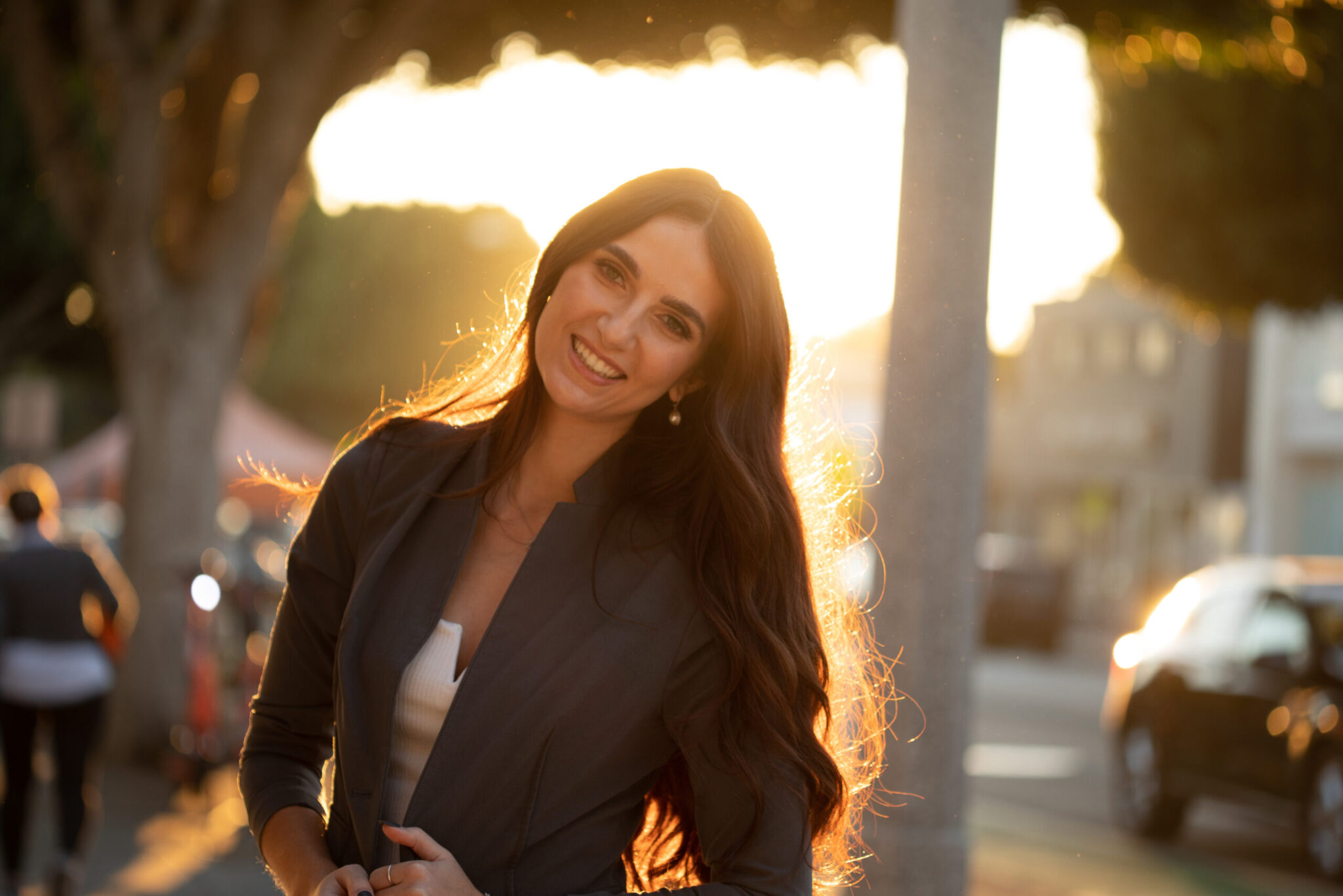 Cheyenne Hunt posing for a photo in an urban street area with head slightly tilt