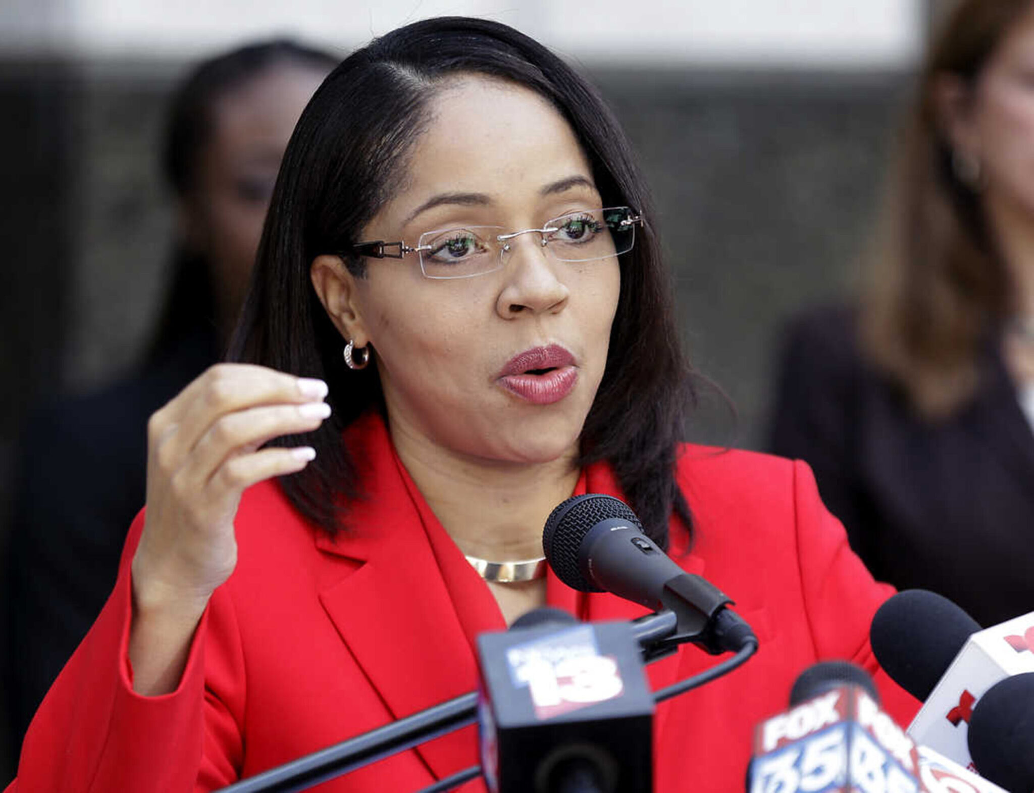 Aramis Ayala dressed in red speaking