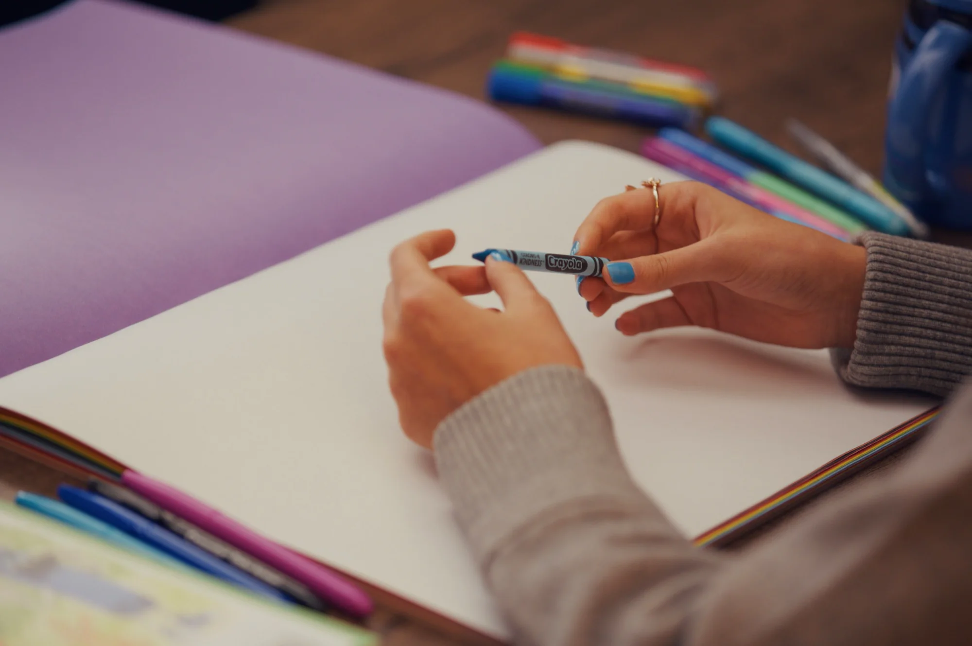 Crayola artist drawing with crayon behind the scenes