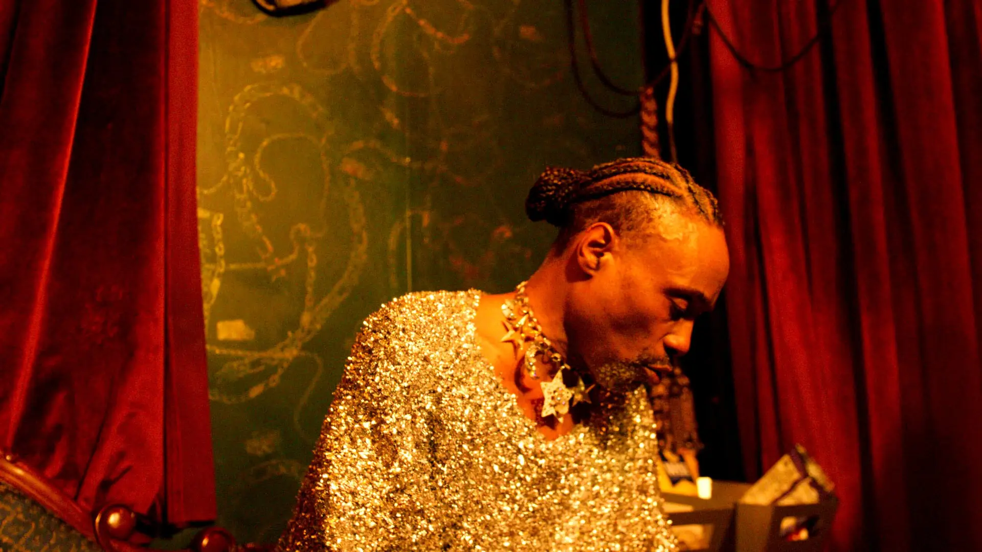 Billy Porter wearing gold sequin jacket in recording studio