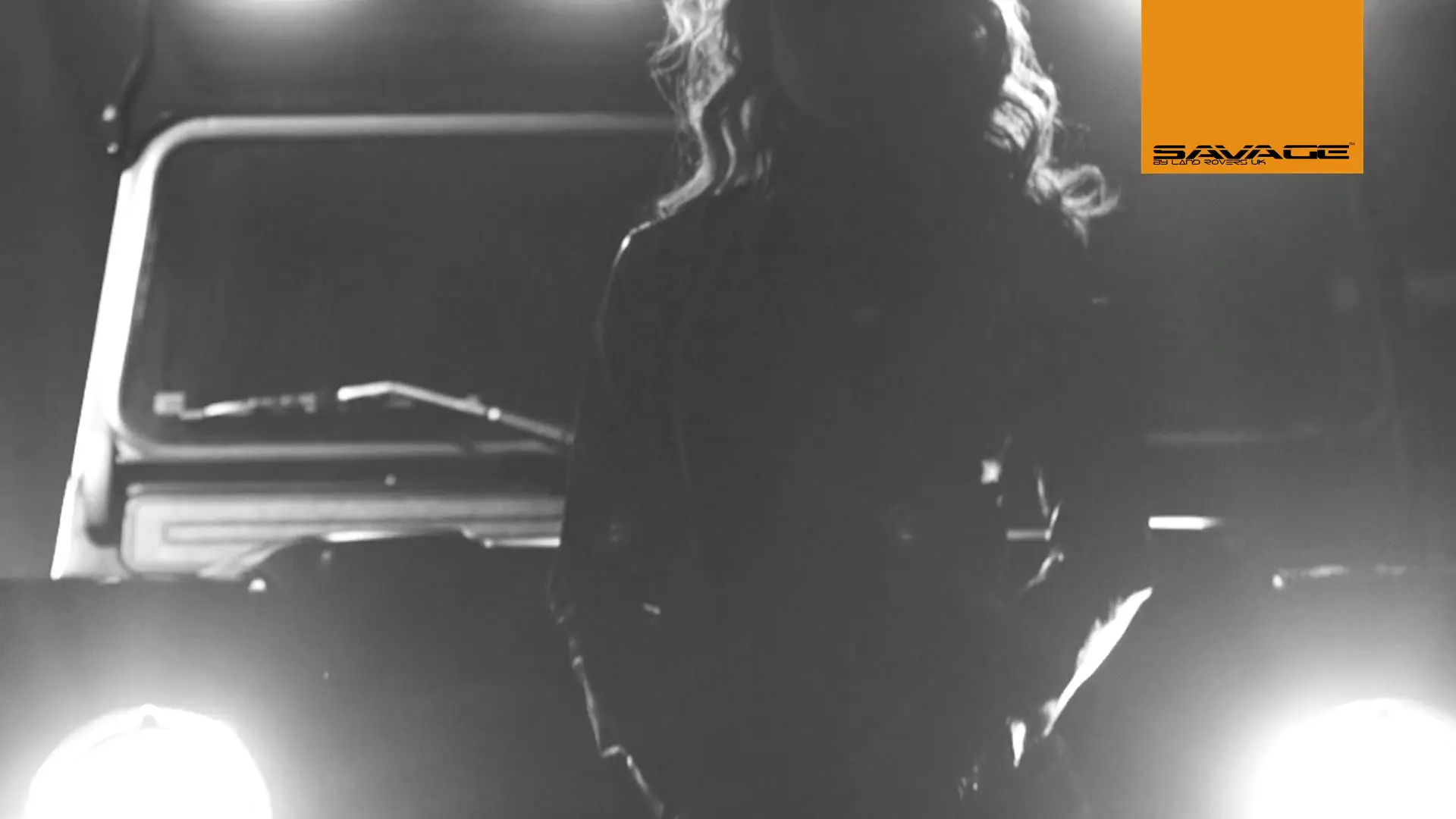 Land Rover UK Savage Defender 2 Woman silhouetted against Land Rover Defender in studio
