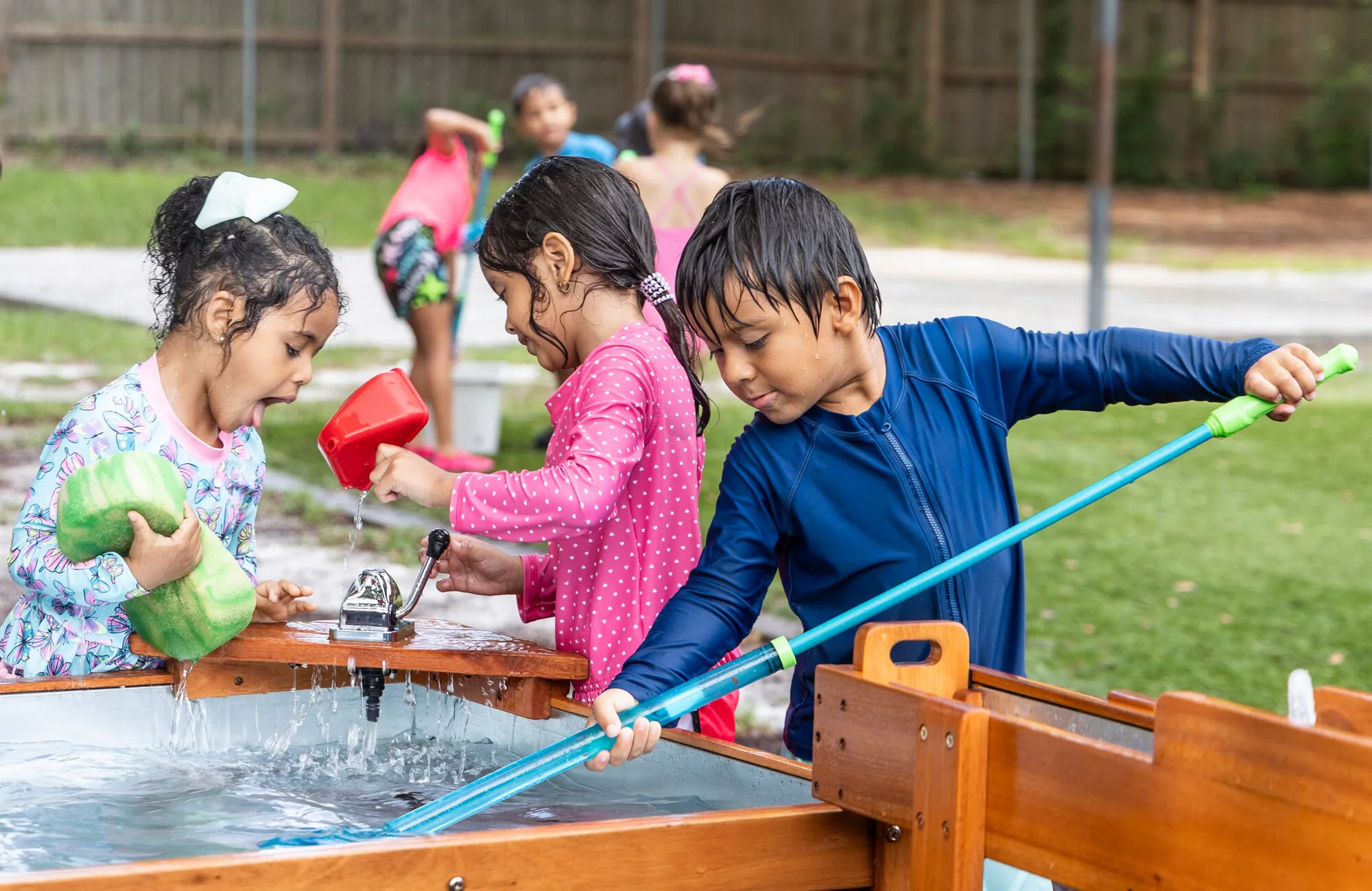 Florida Department of Children and Families 4 Florida Children System of Care young children playing at outdoor water table