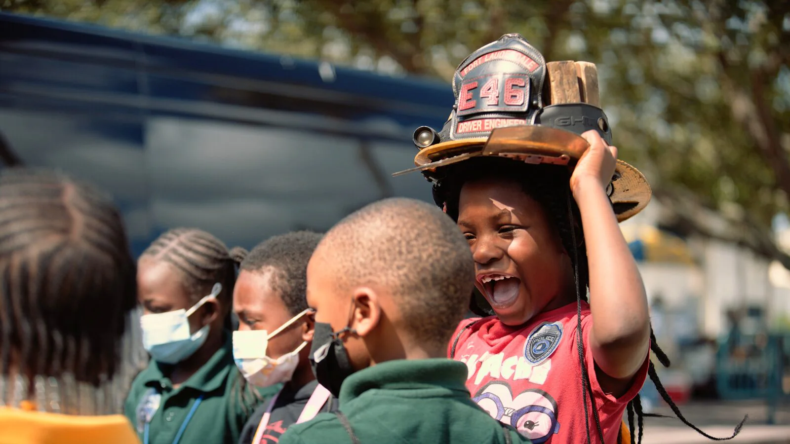 Ranger Technical Resources 3 Dillard Elementary student laughing while trying on a firefighter helmet at Ranger Good Works Career City