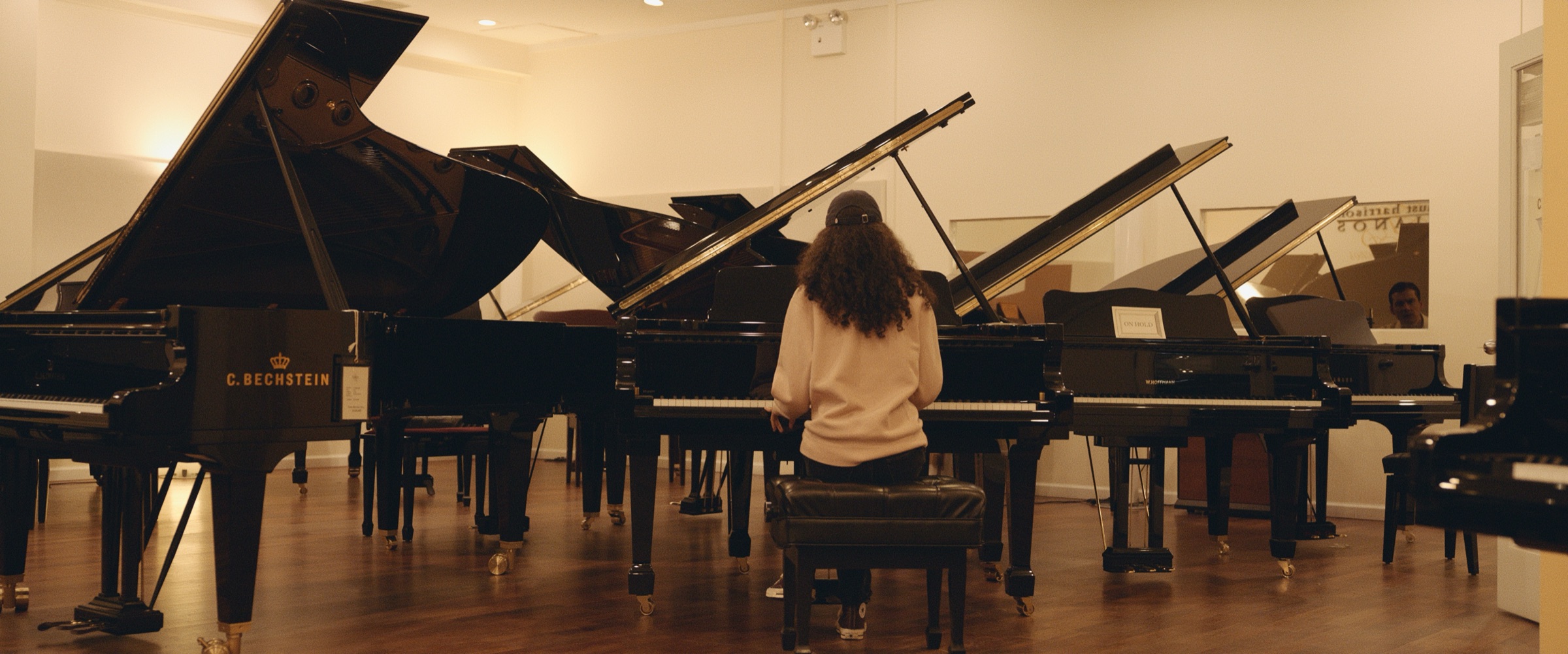 Pianos and Rooftops 4 Scene shot in a hall of grand pianos
