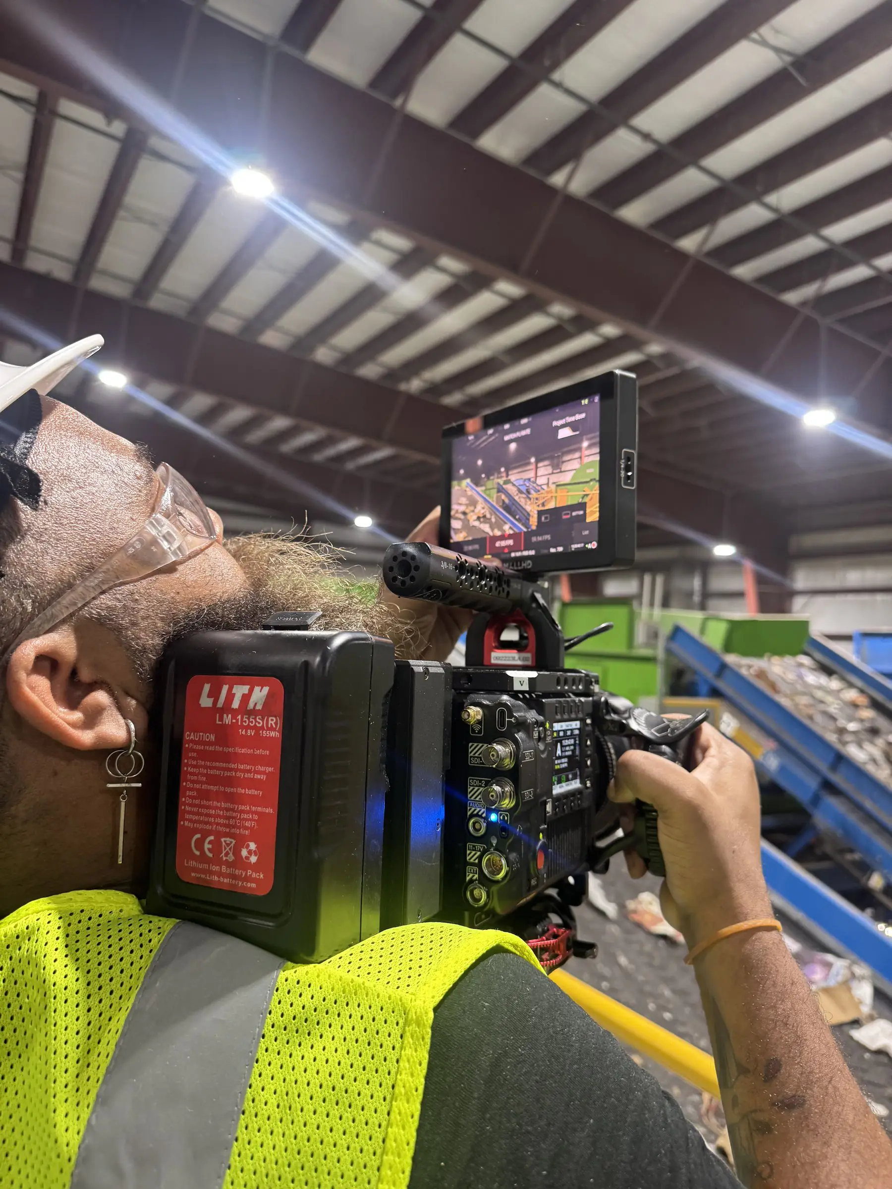 Conceptual Communications: Waste Management 29 C&I Studios camera operator filming b roll at the Waste Management recycling facility