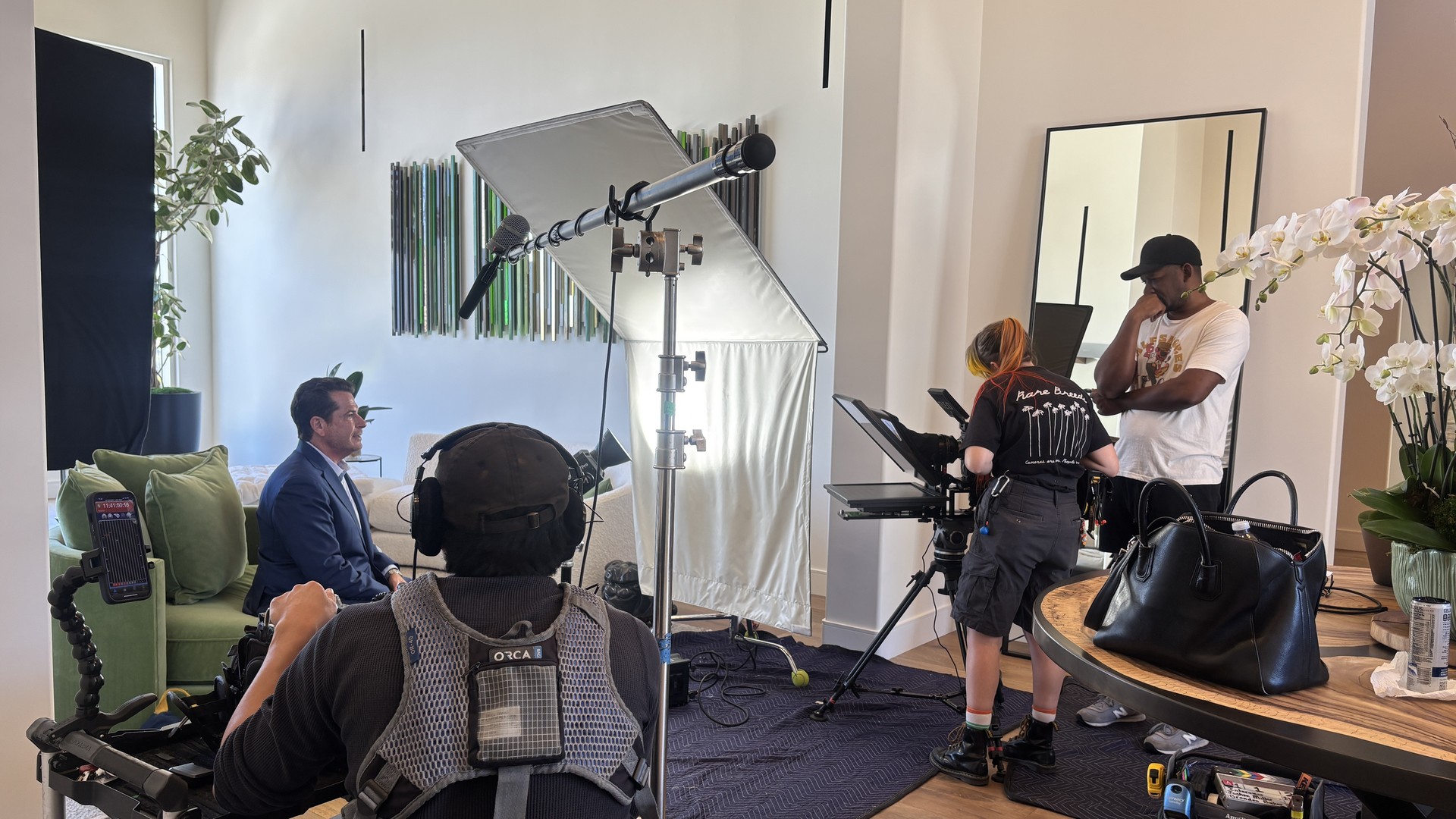 Acrisure 2 Acrisure vertical video production crew lighting the living room set