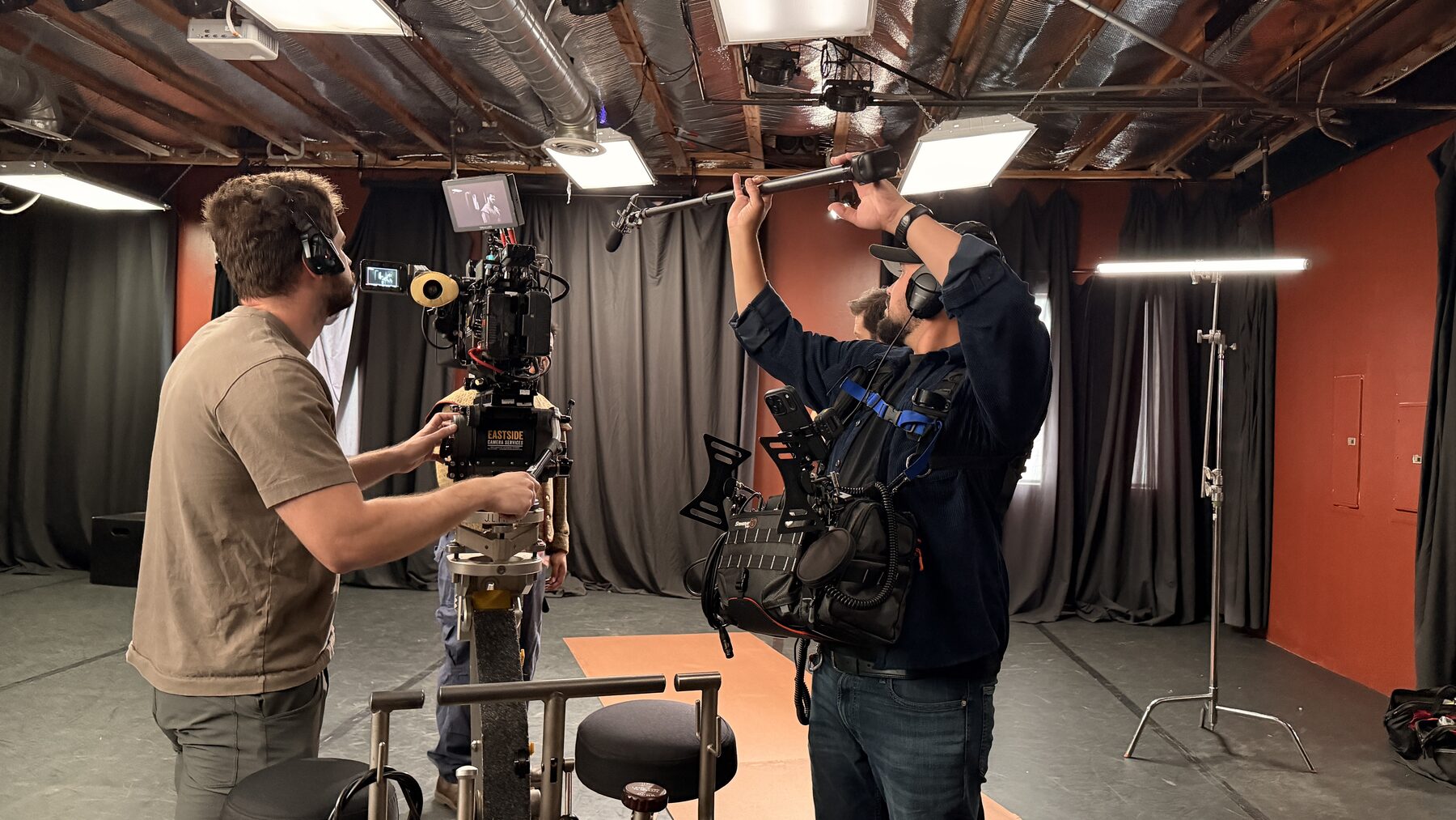 The Loudest Voice 3 Camera and sound crew setting up under the studio lighting grid