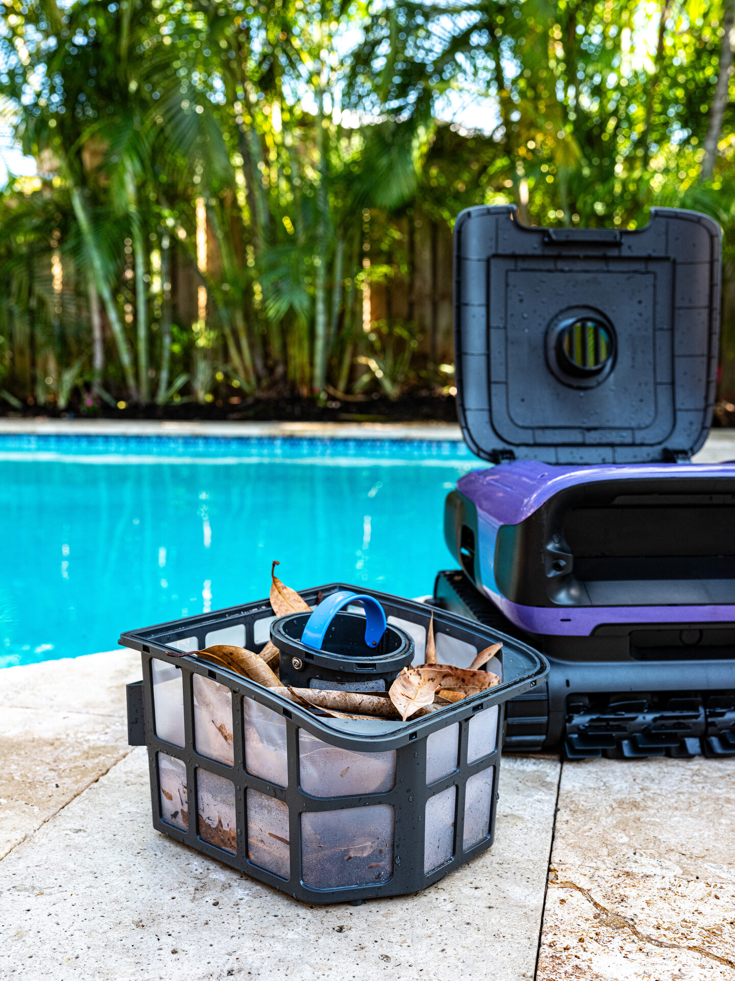 BeatBot 10 BeatBot Sora 70 debris basket filled with leaves beside the pool