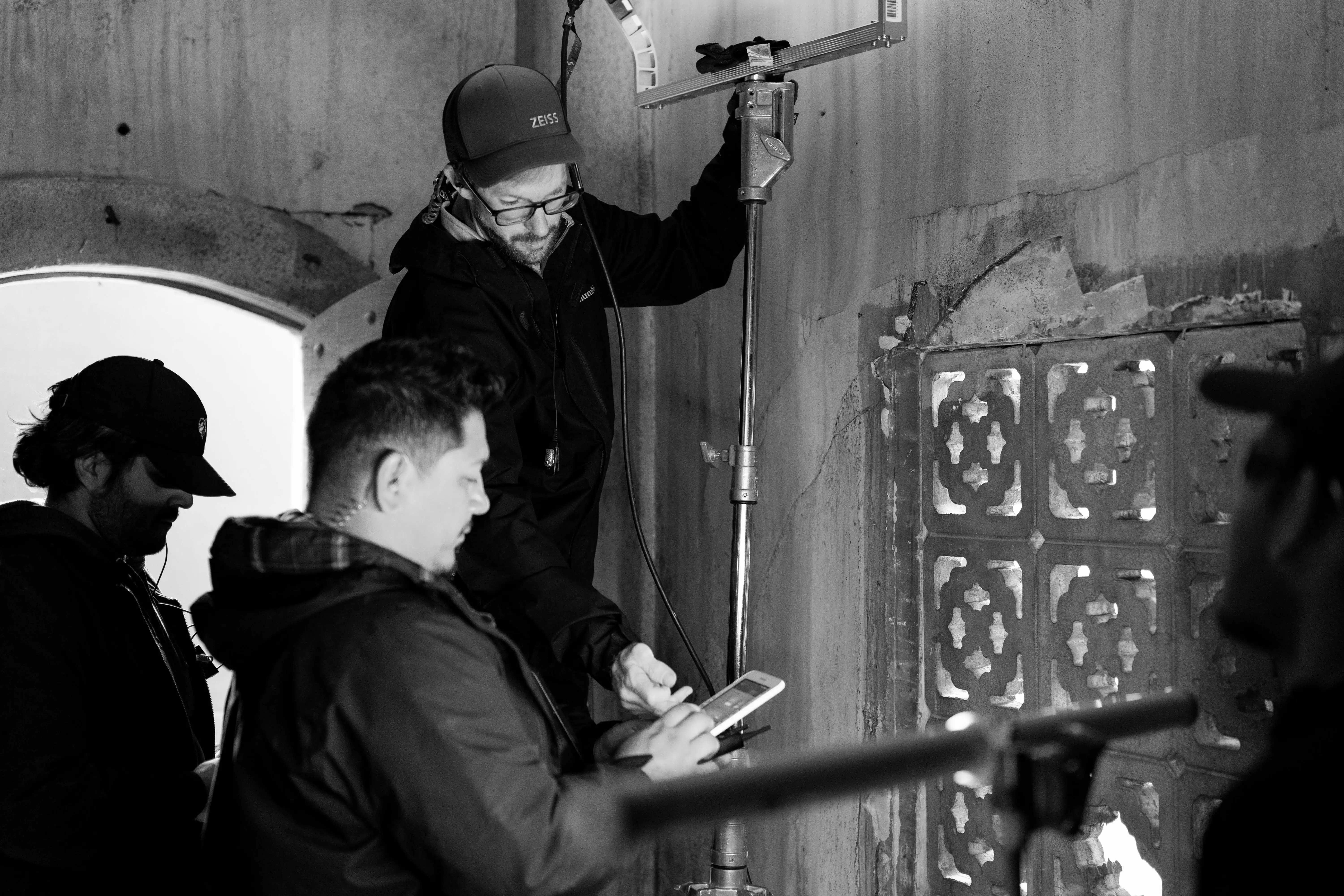 How Much Does Commercial Video Production Cost in 2026? 4 C&I Studios crew rigging a light on a commercial shoot