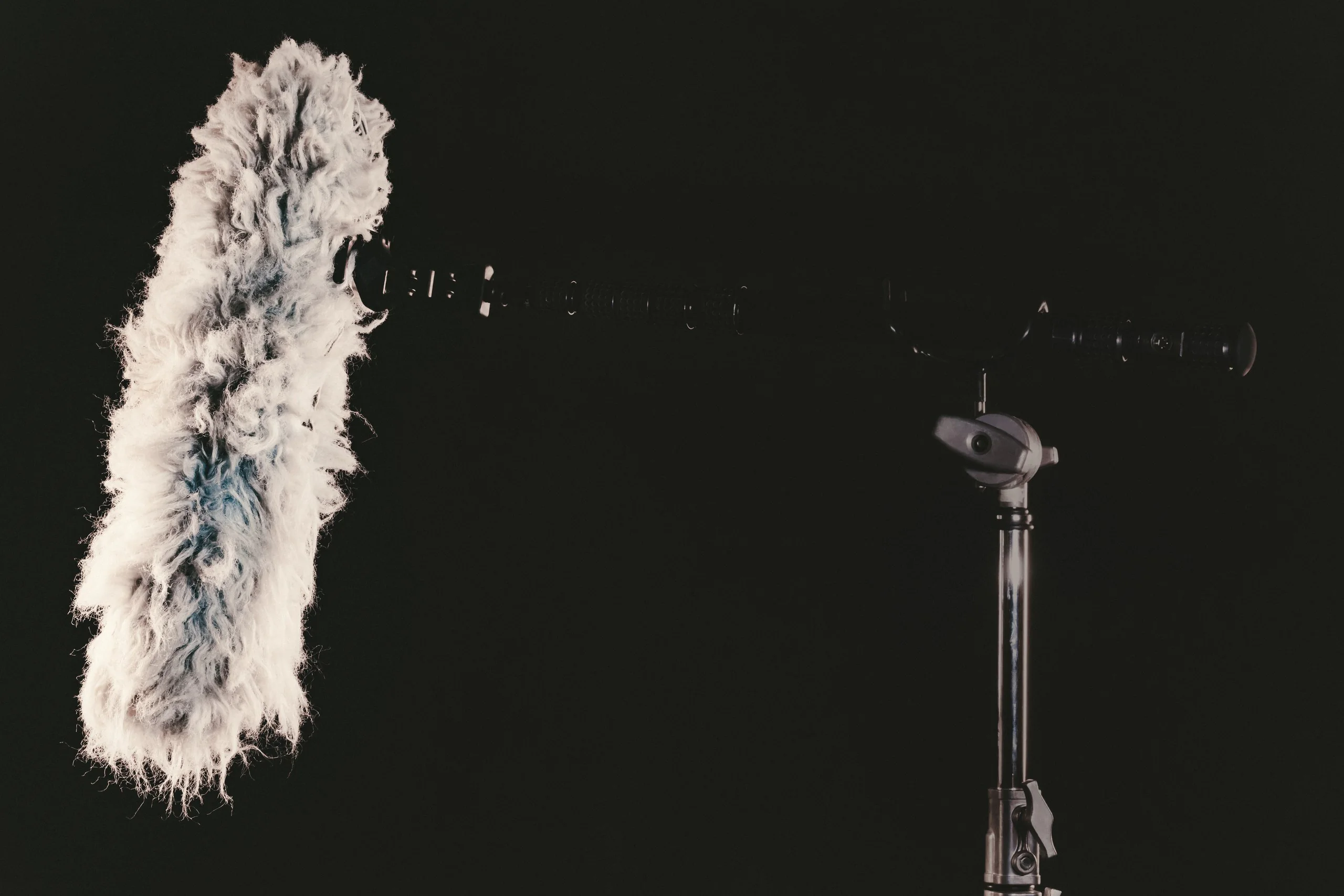 Production Gear 23 Shotgun microphone with a windjammer mounted on a stand